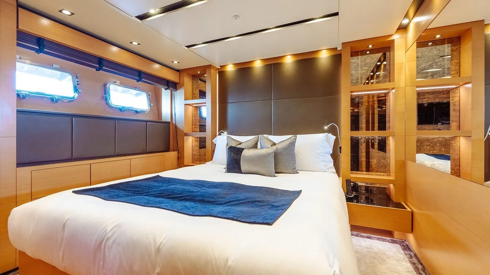 a room with a bed and a tv aboard AWAY Yacht for Charter