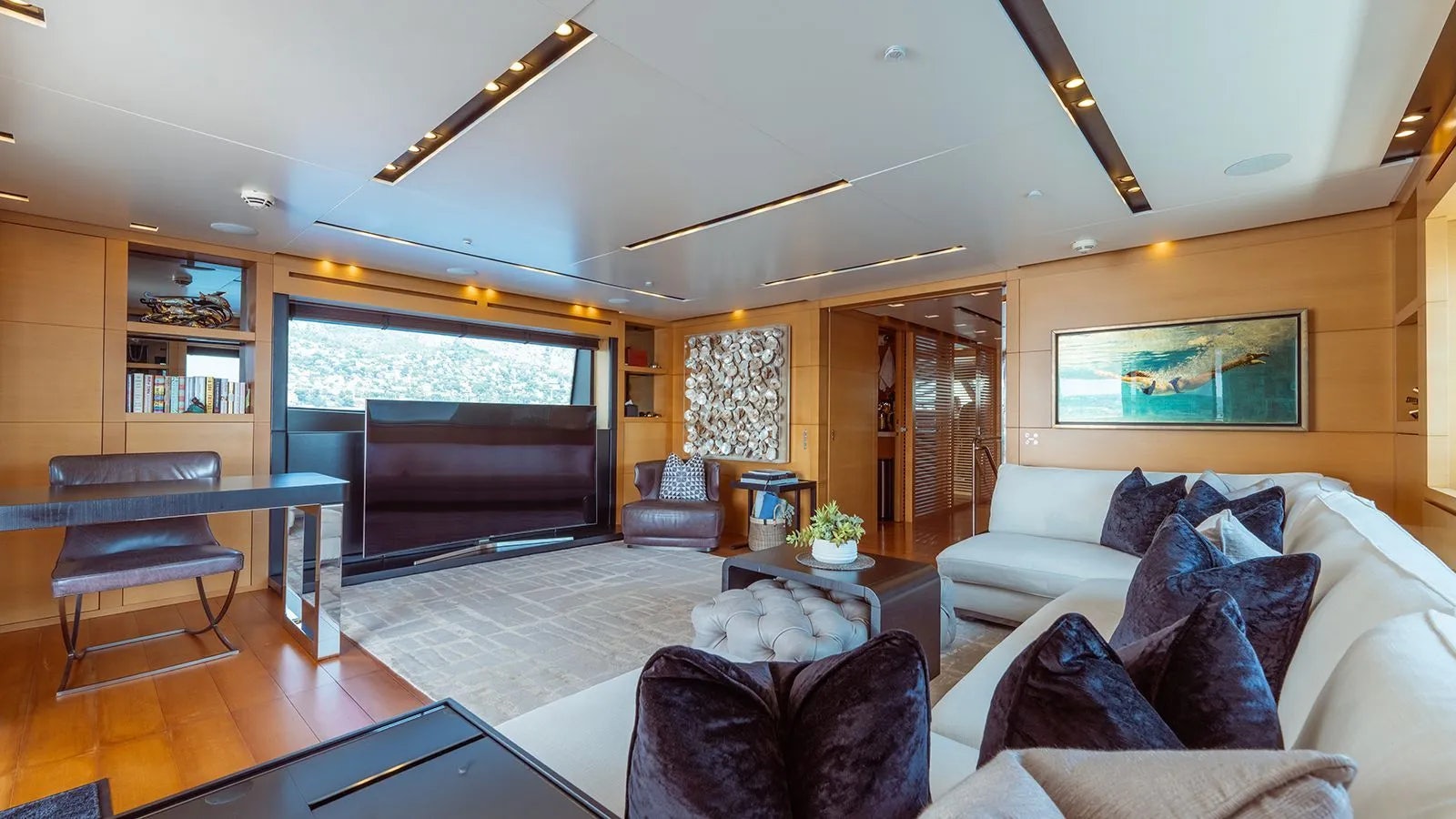 a living room with a large window aboard AWAY Yacht for Charter