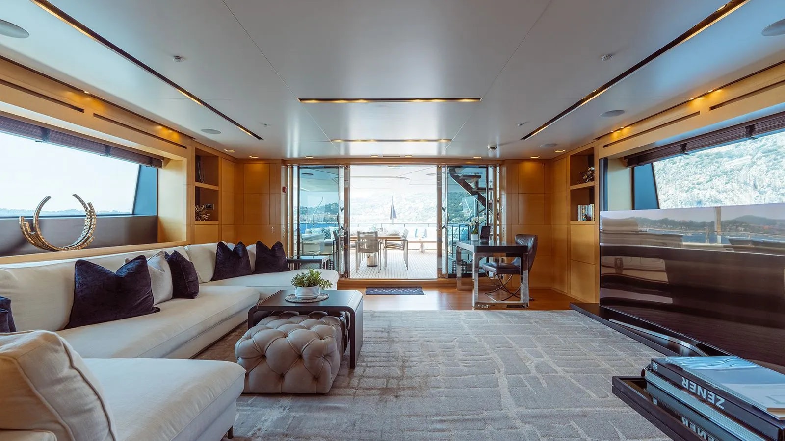a living room with a large window aboard AWAY Yacht for Charter