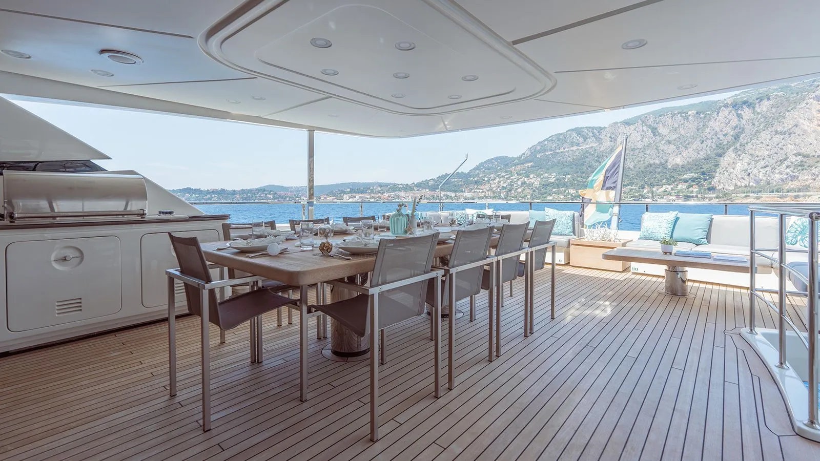 a deck with a table and chairs on it aboard AWAY Yacht for Charter