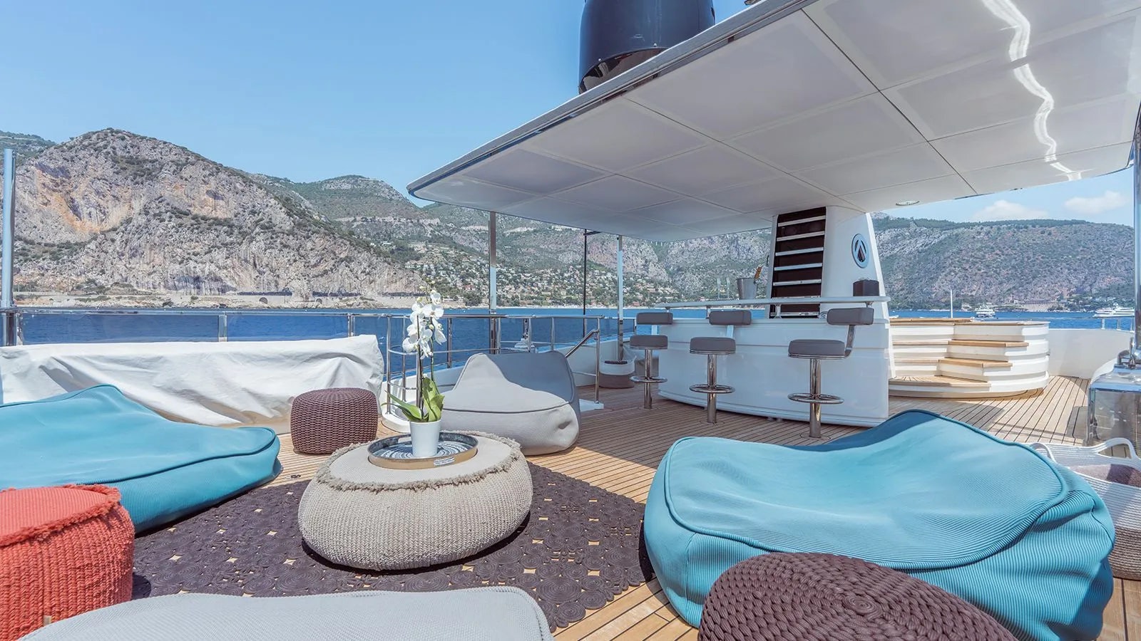 a room with a table chairs and a large white tent aboard AWAY Yacht for Charter