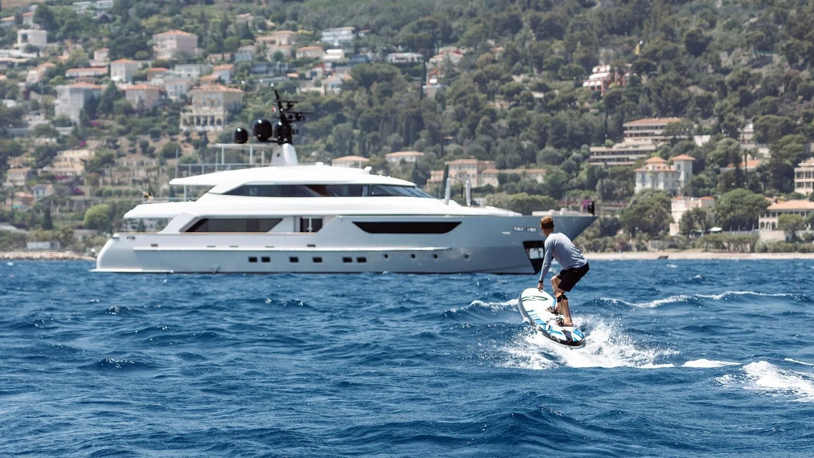 a man surfing on the sea aboard AWAY Yacht for Charter