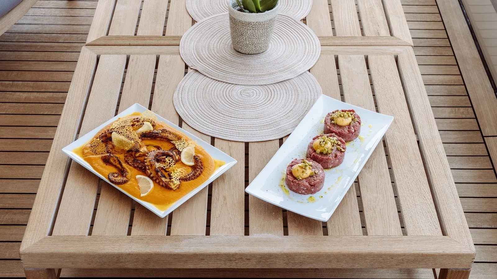 a plate of food on a table aboard AWAY Yacht for Charter