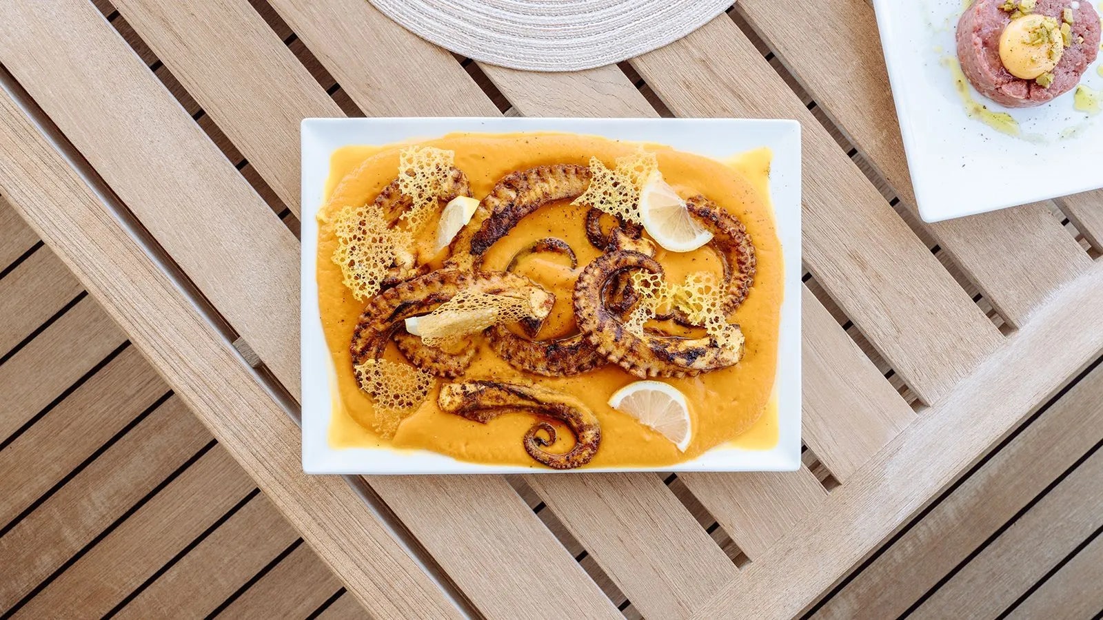 a plate of food aboard AWAY Yacht for Charter