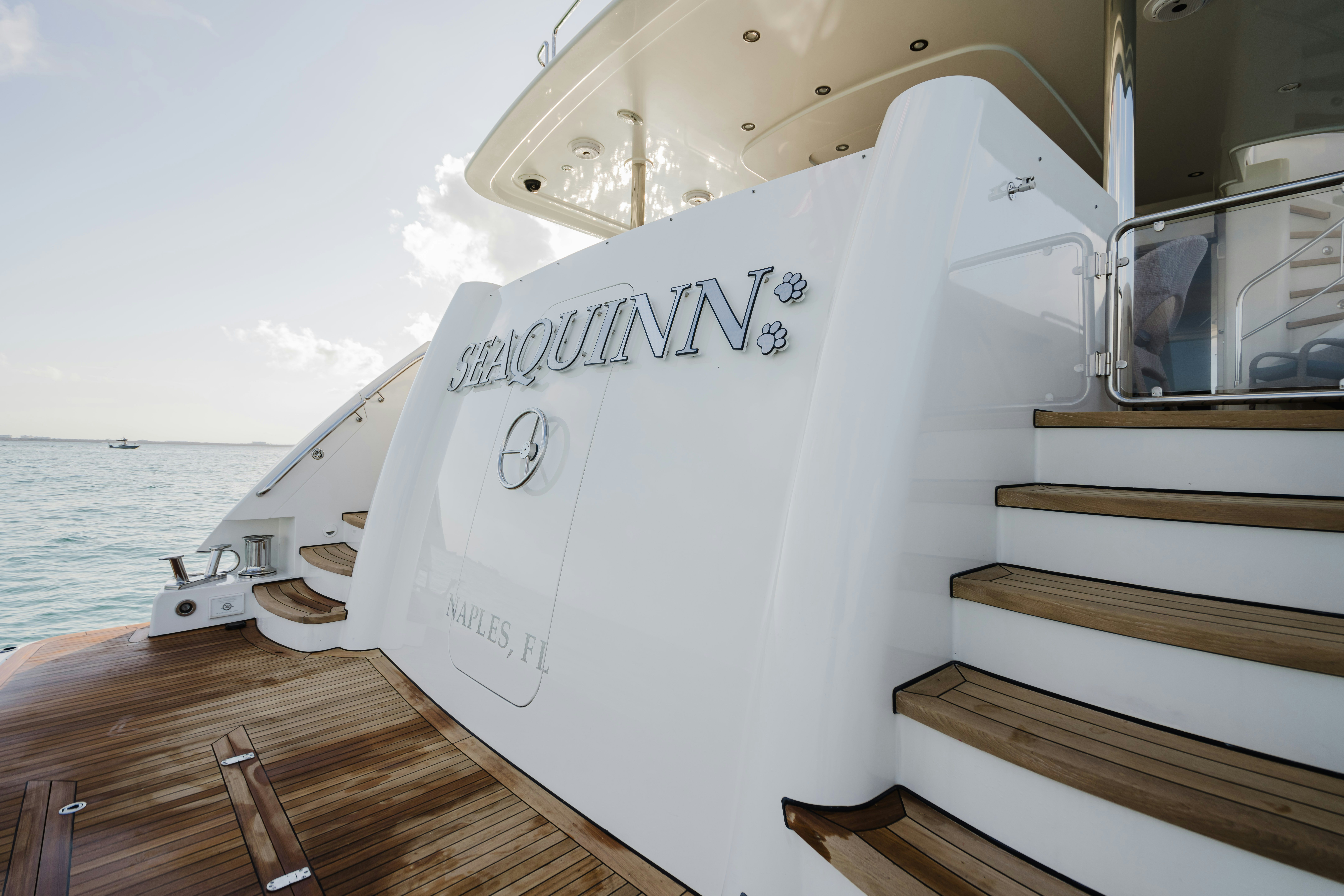 a white boat on a dock aboard SEAQUINN Yacht for Sale