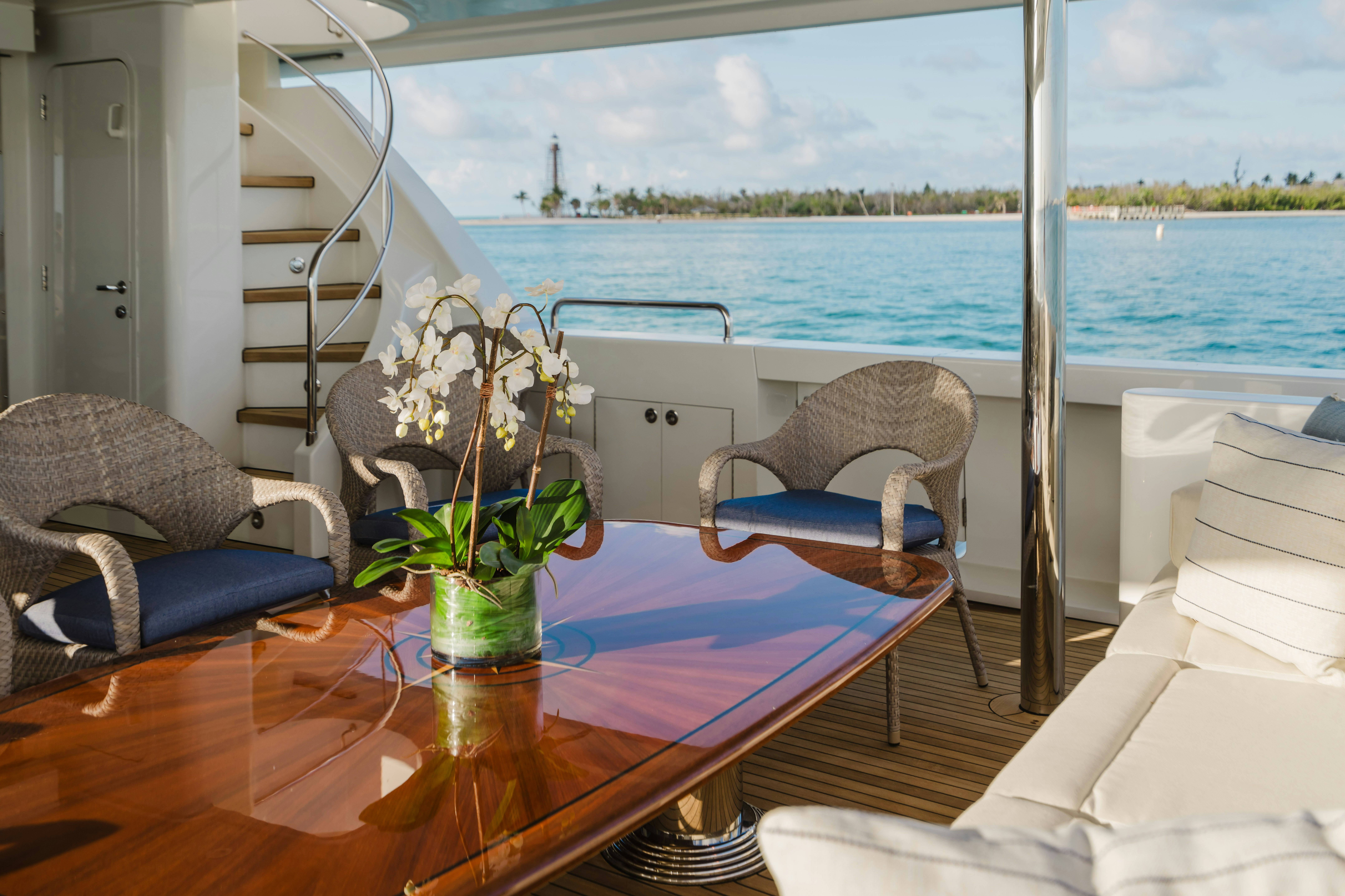 a table with chairs and a plant on it aboard SEAQUINN Yacht for Sale