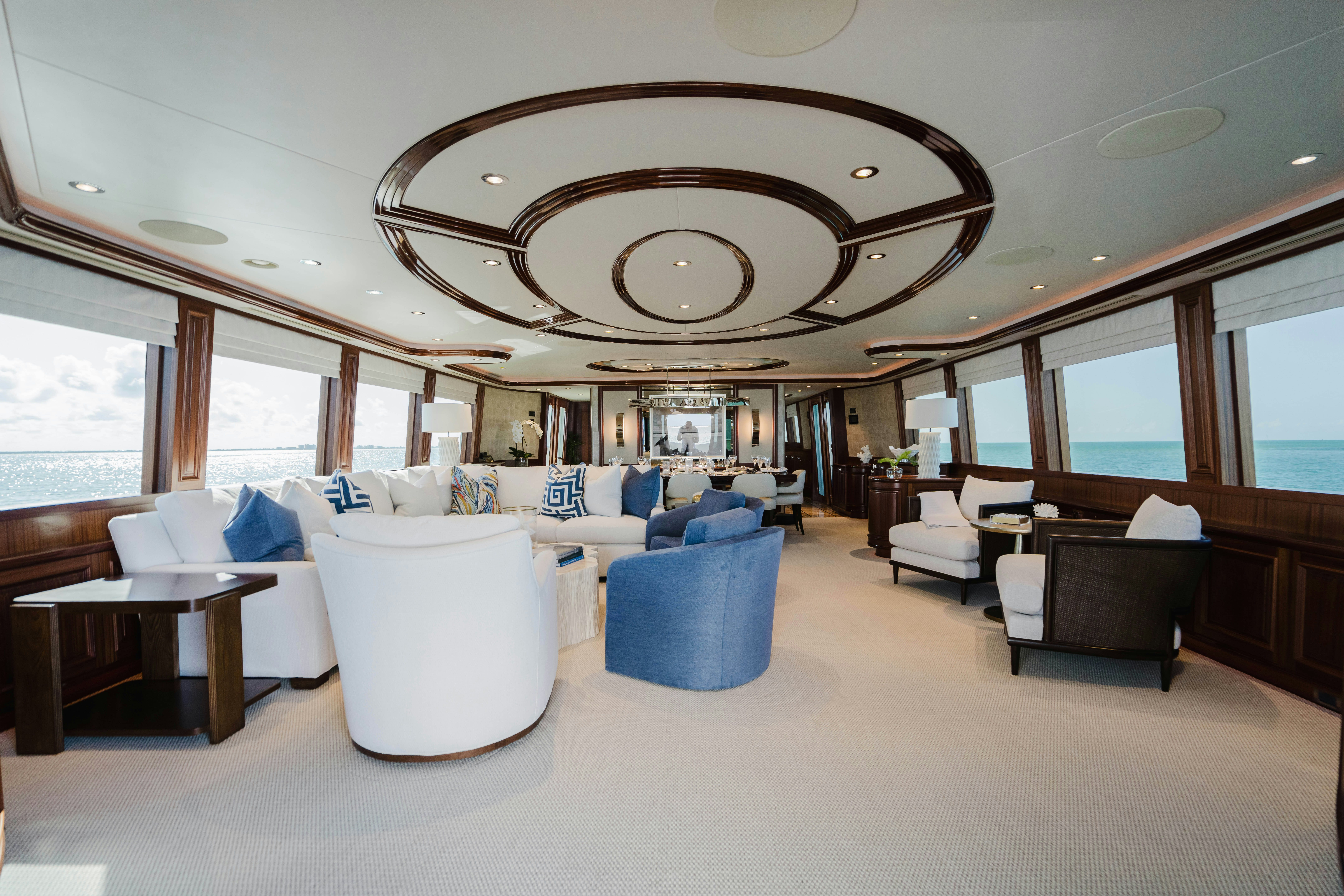 a large living room with a chandelier aboard SEAQUINN Yacht for Sale