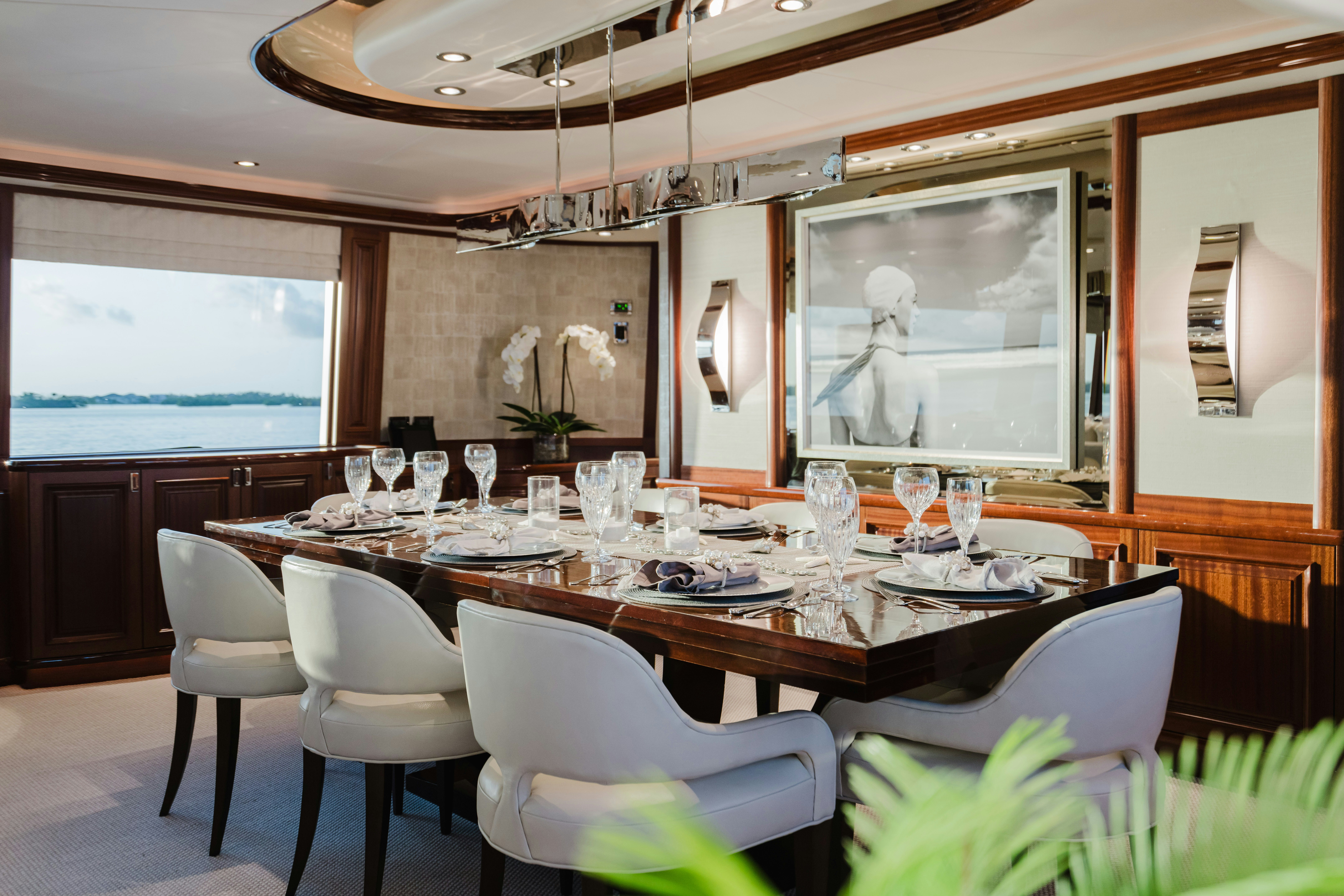 a large dining table with white chairs aboard SEAQUINN Yacht for Sale