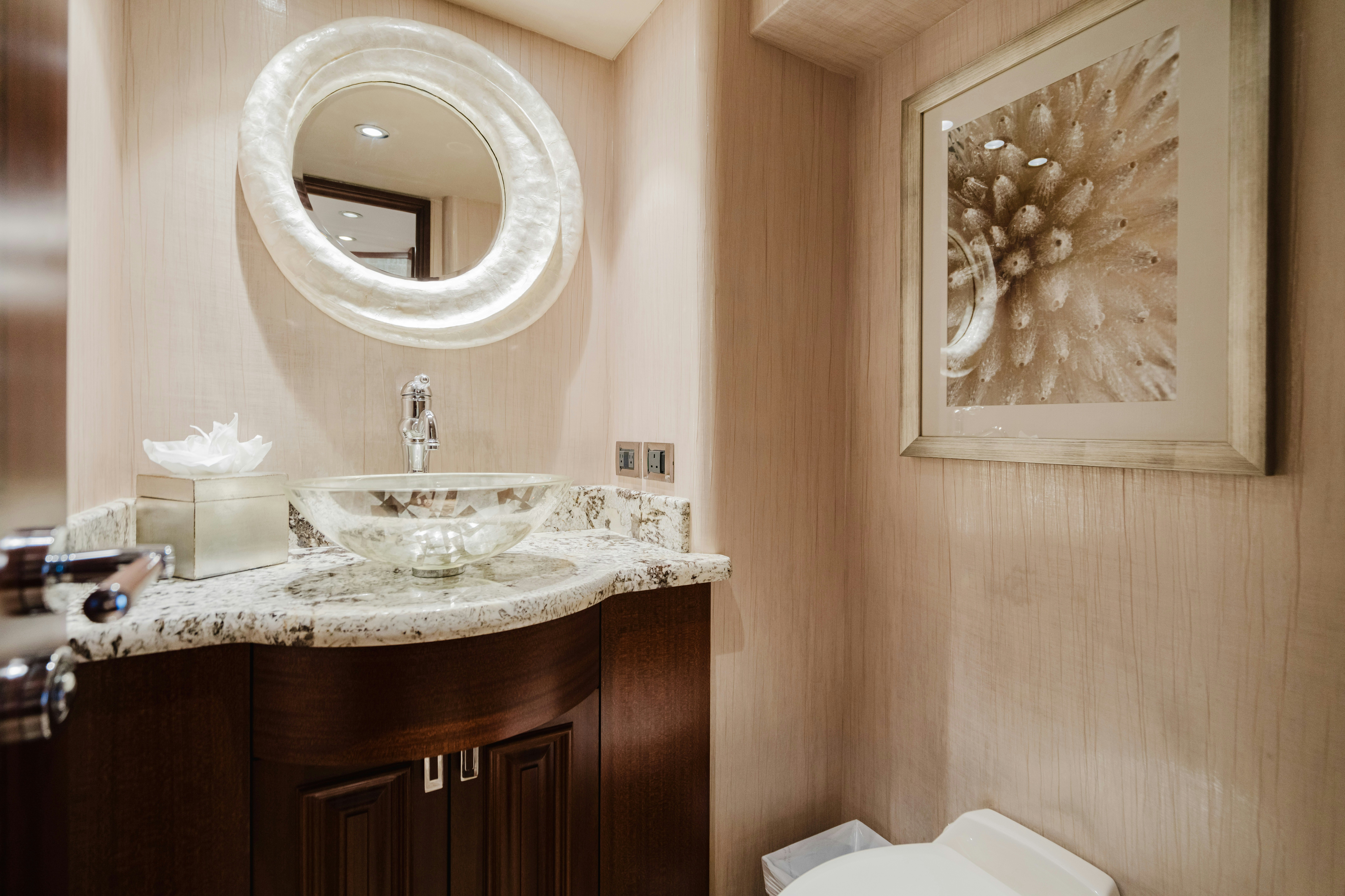 a bathroom with a round mirror aboard SEAQUINN Yacht for Sale
