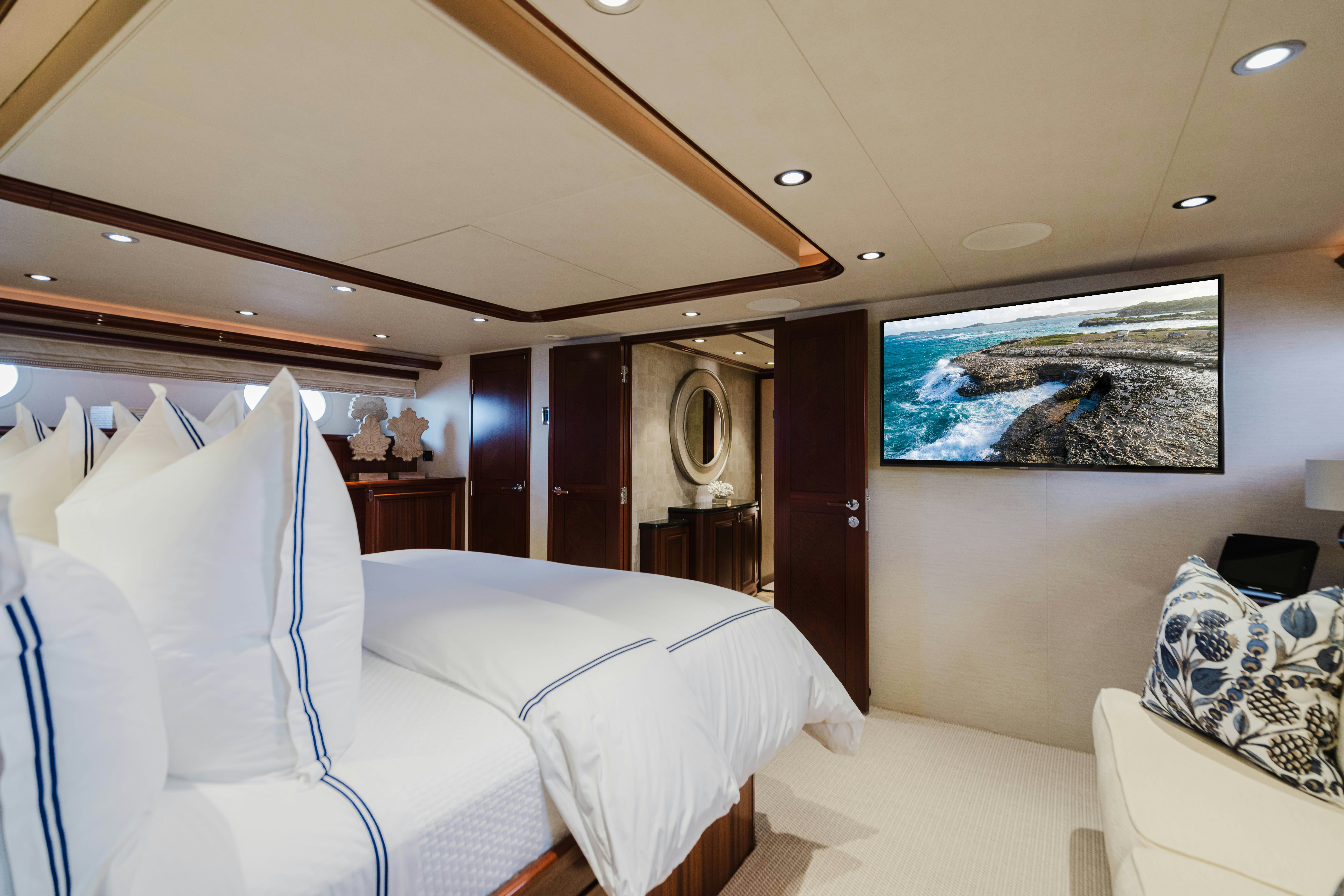 a room with a bed and a mirror aboard SEAQUINN Yacht for Sale