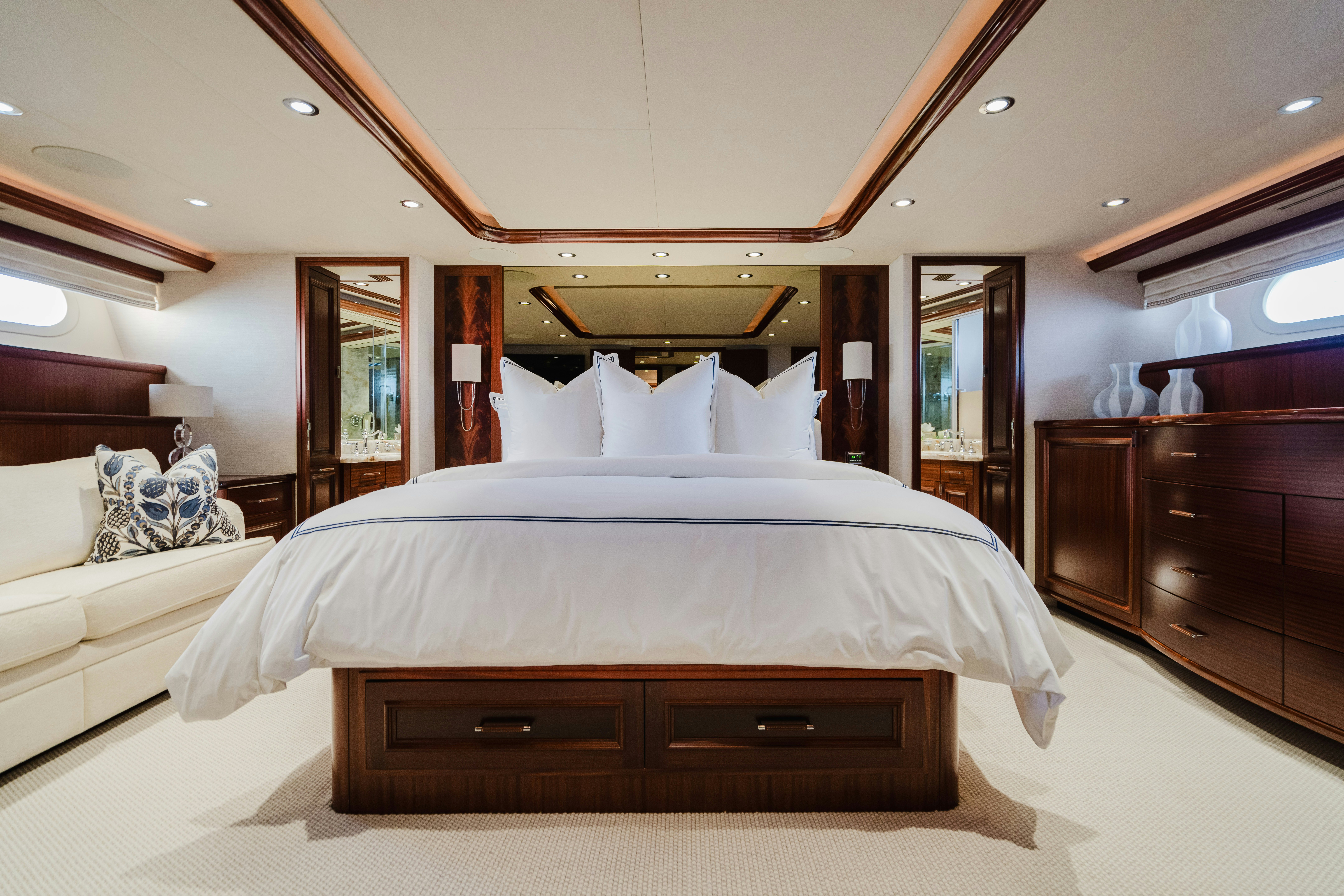 a bedroom with a bed and a dresser aboard SEAQUINN Yacht for Sale