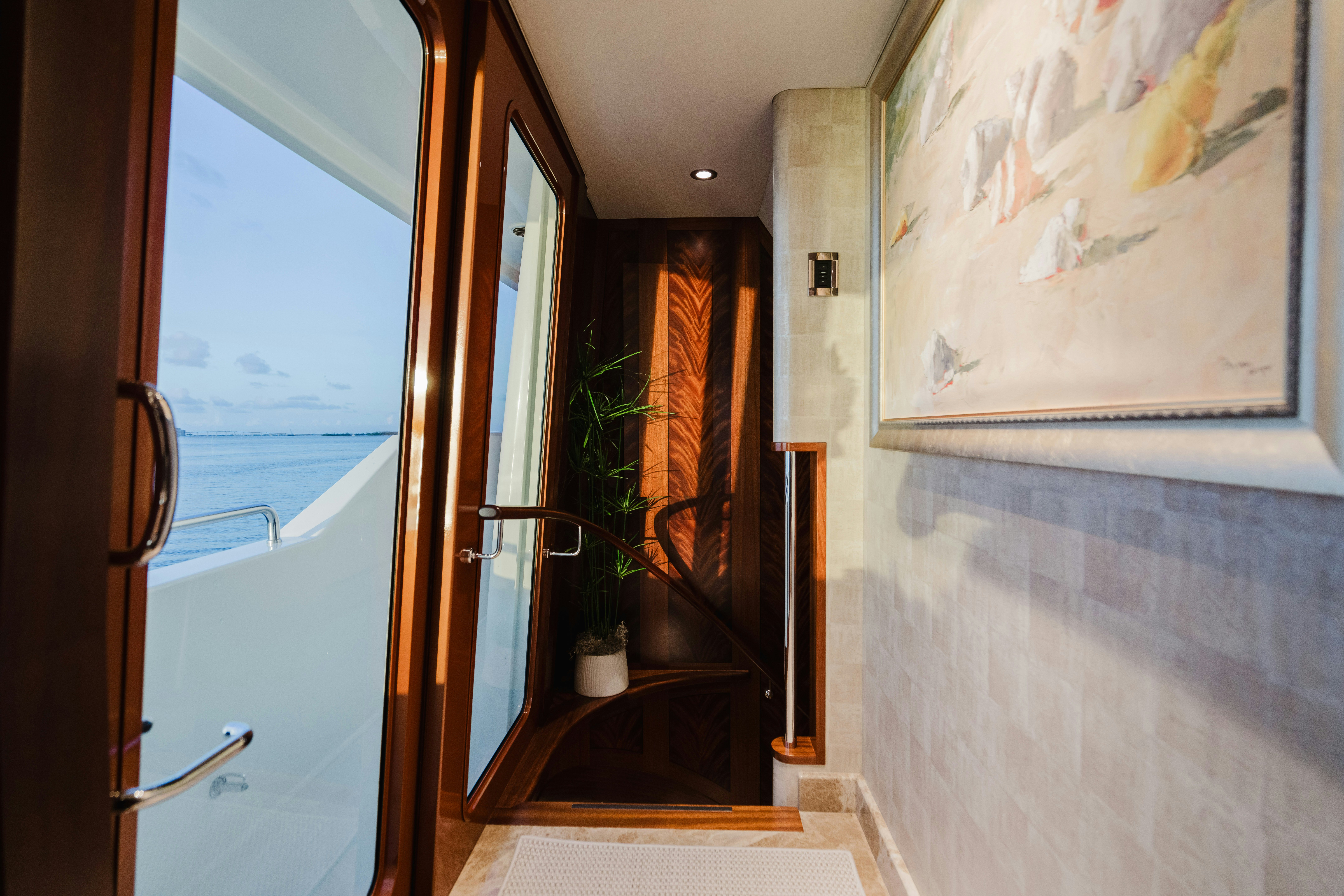 a hallway with a glass door aboard SEAQUINN Yacht for Sale