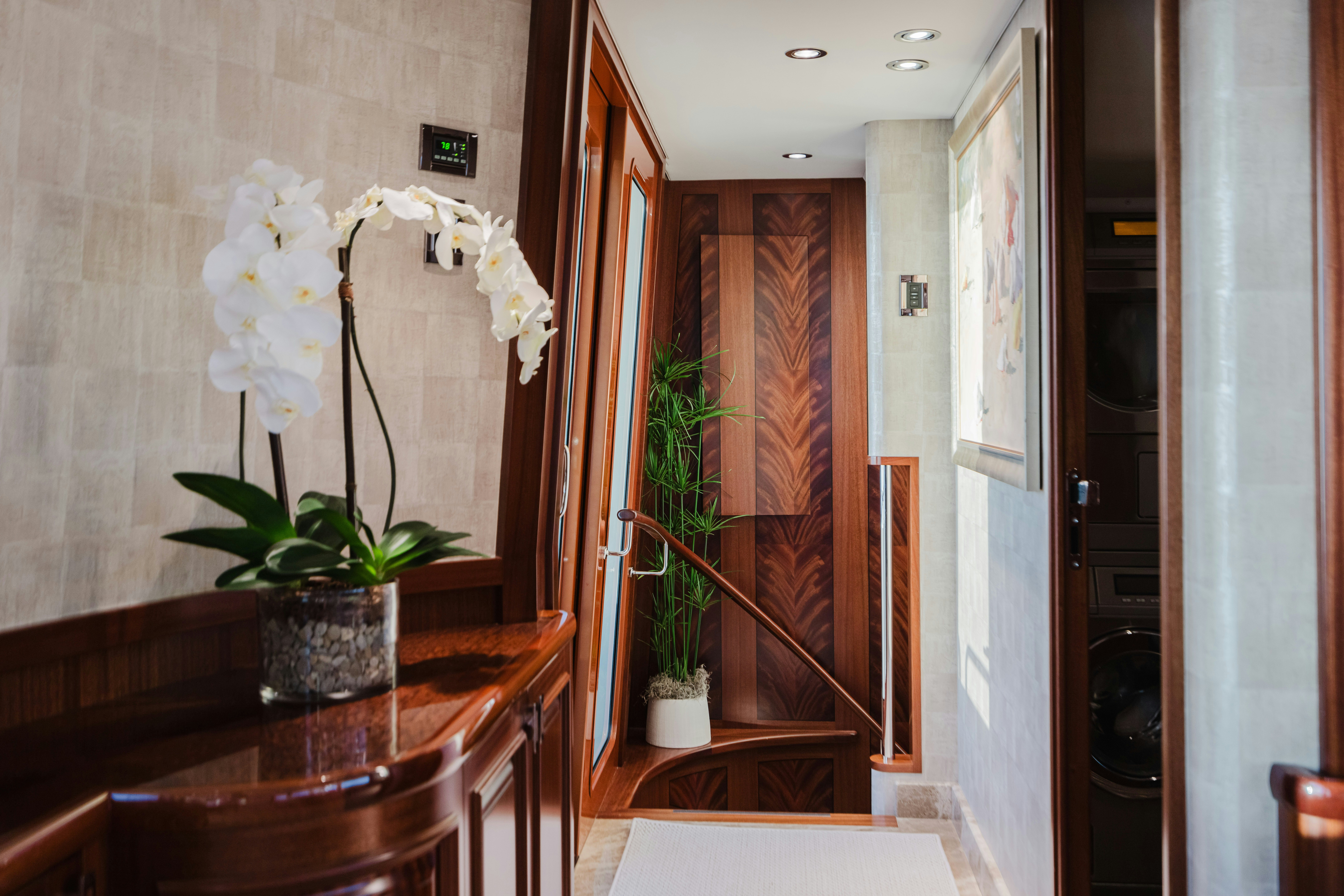 a vase of white flowers on a table aboard SEAQUINN Yacht for Sale