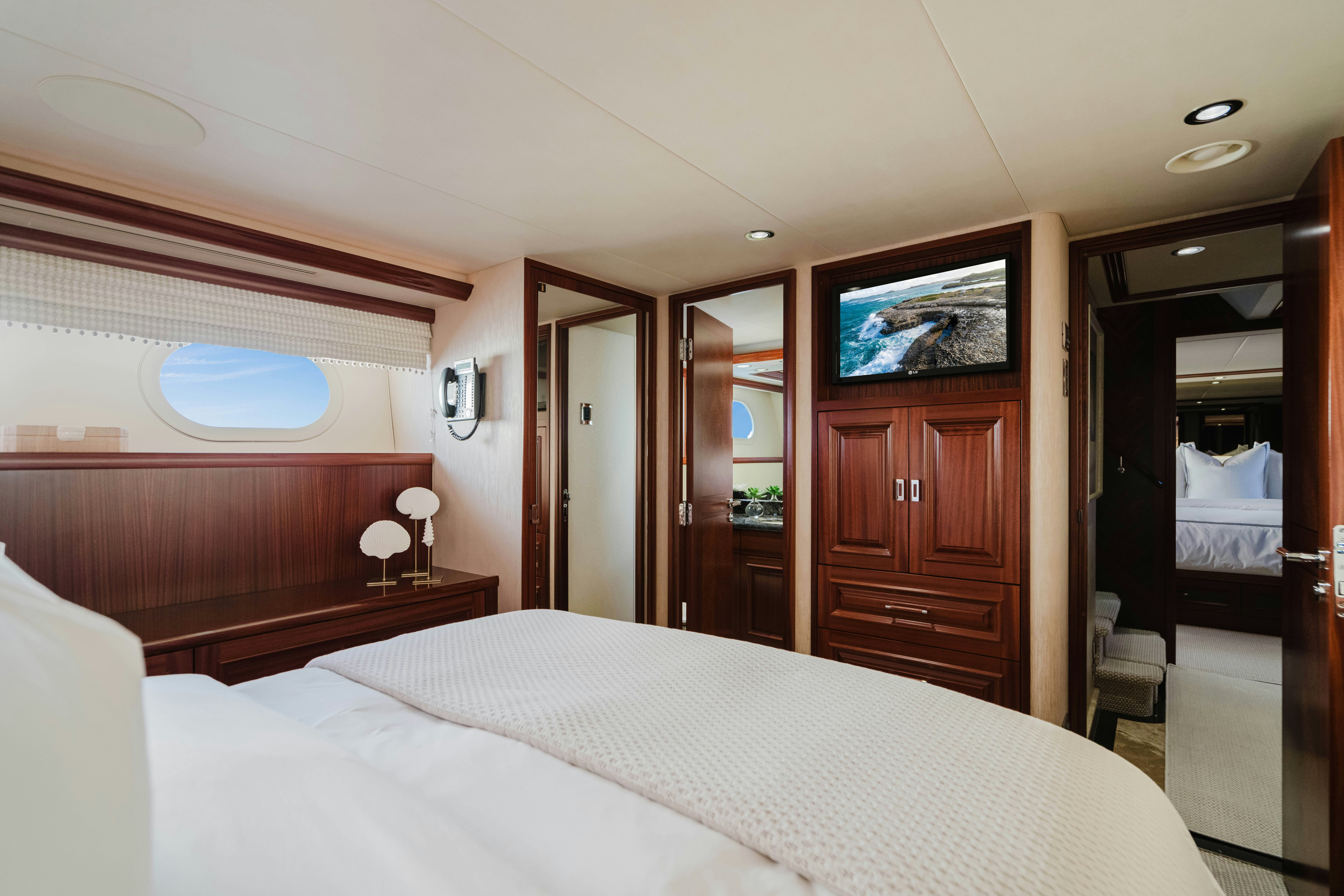 a bedroom with a bed and a closet aboard SEAQUINN Yacht for Sale