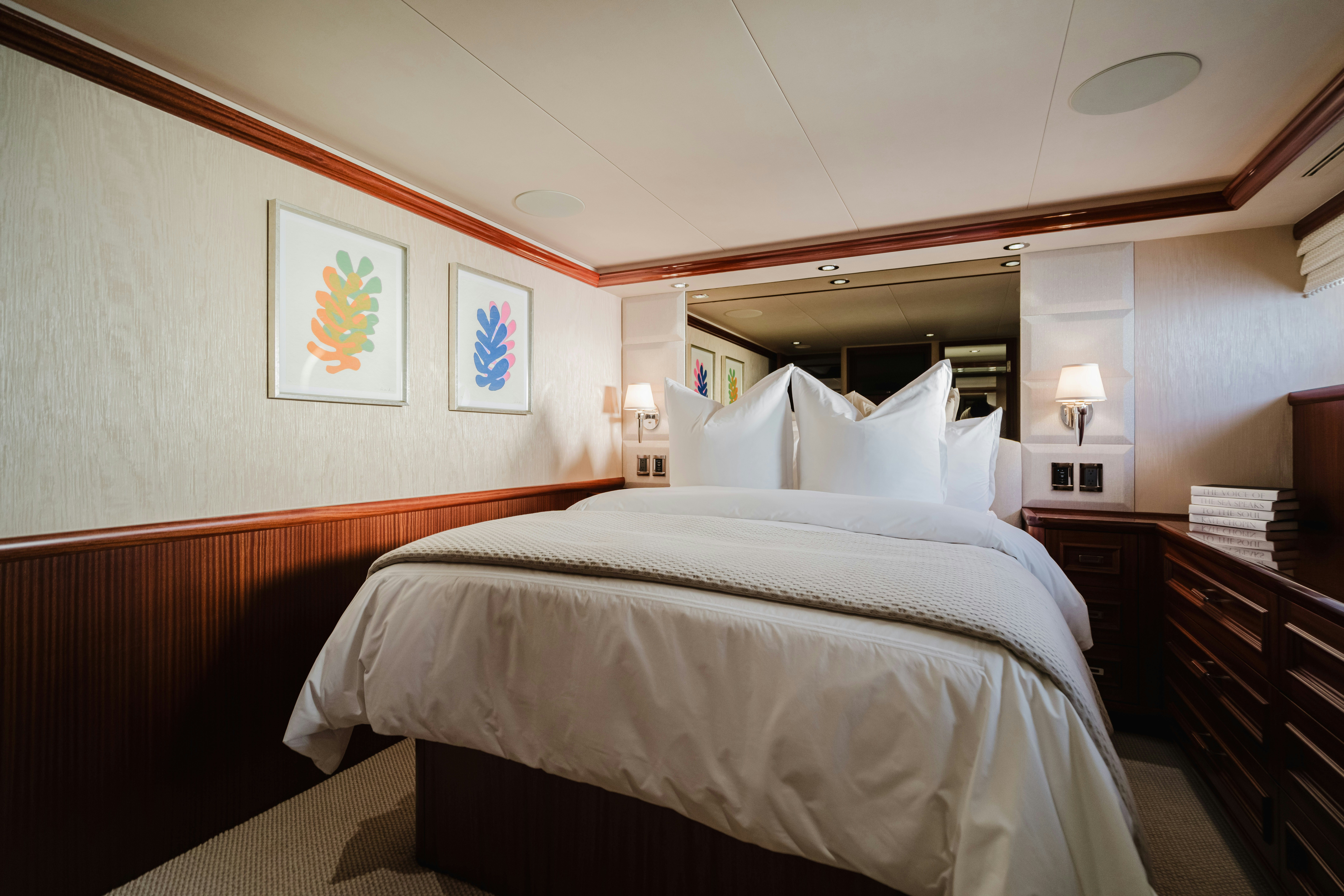 a bedroom with a bed and a desk aboard SEAQUINN Yacht for Sale