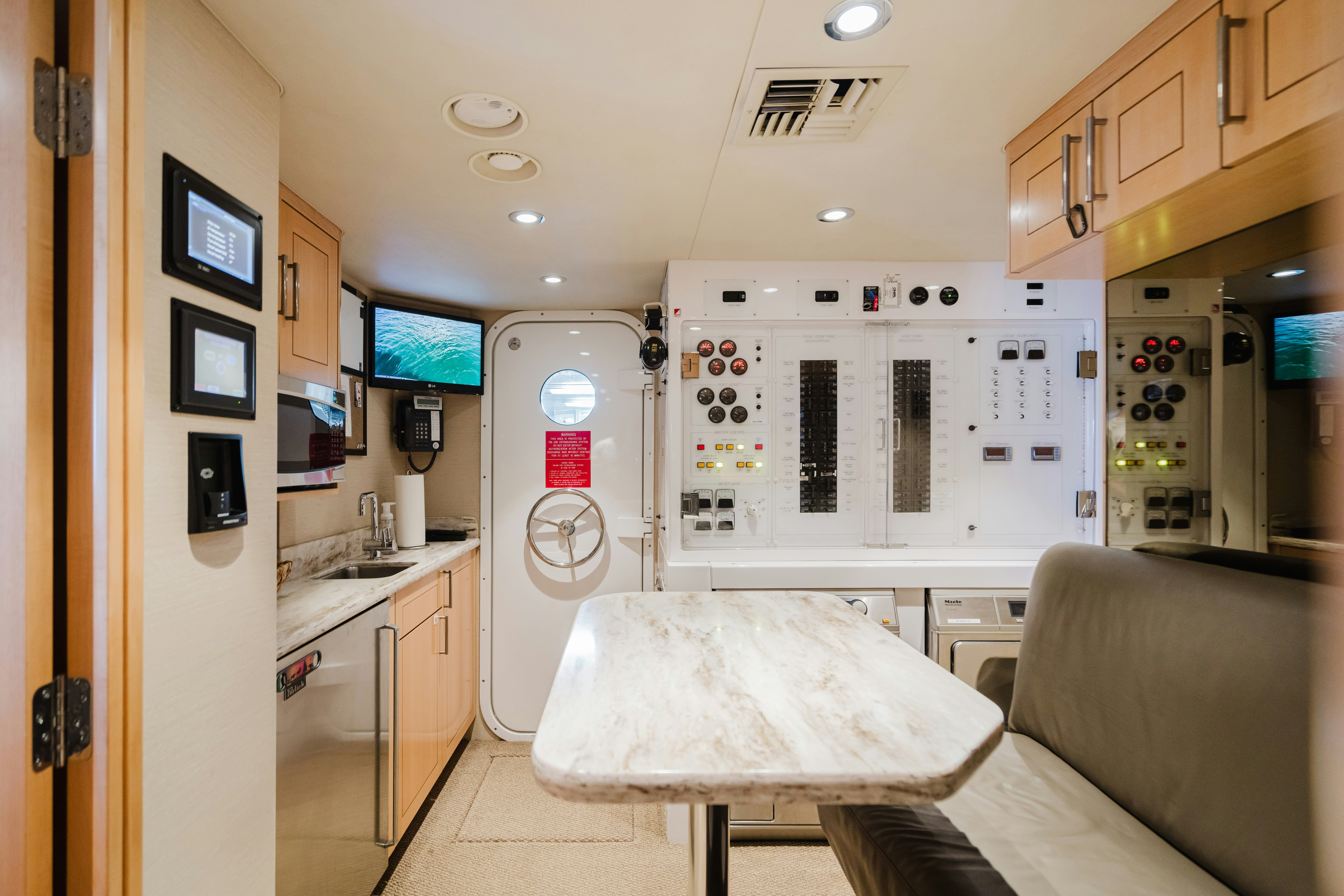 a kitchen with a table and refrigerator aboard SEAQUINN Yacht for Sale