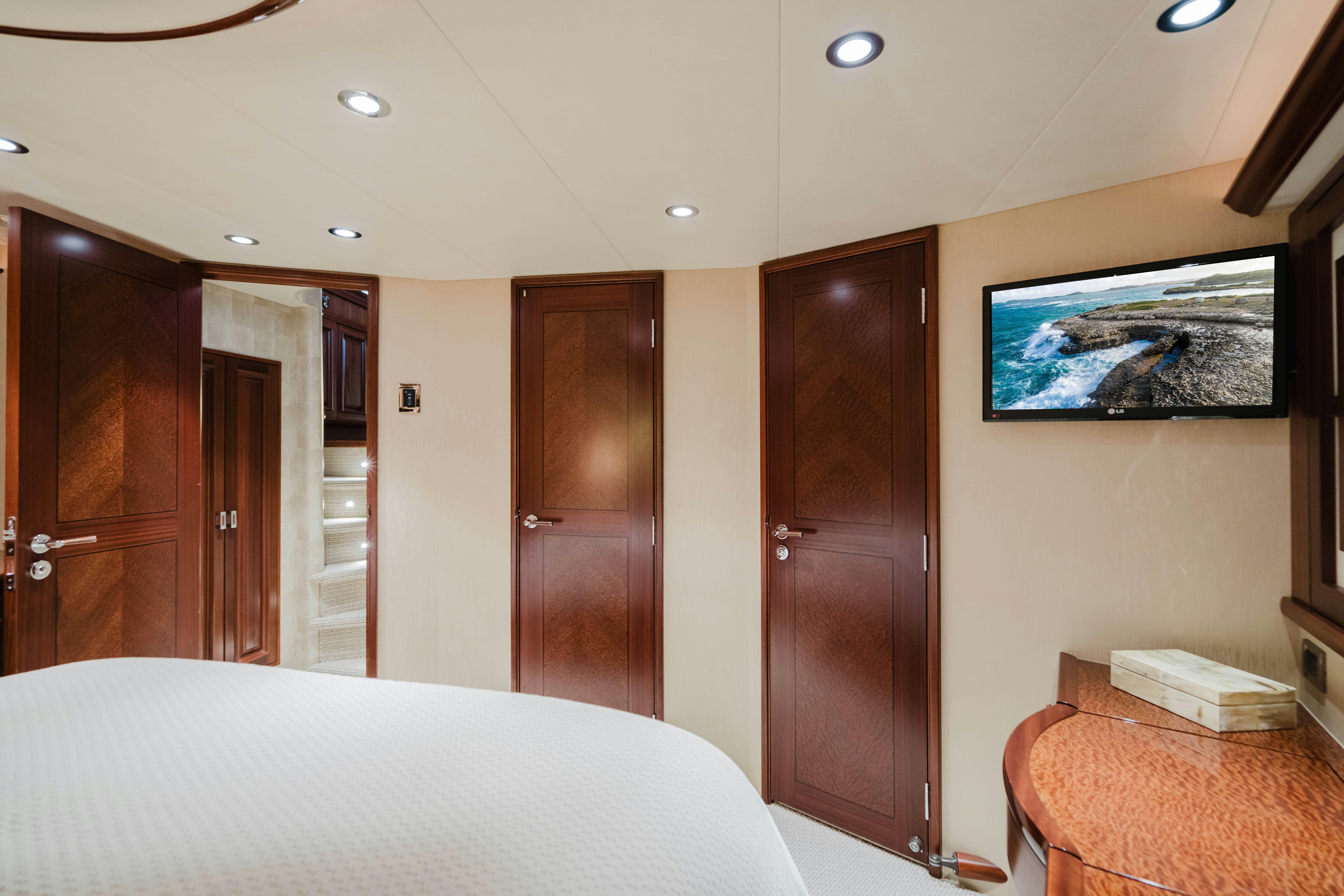 a hotel room with a bed and a television aboard SEAQUINN Yacht for Sale