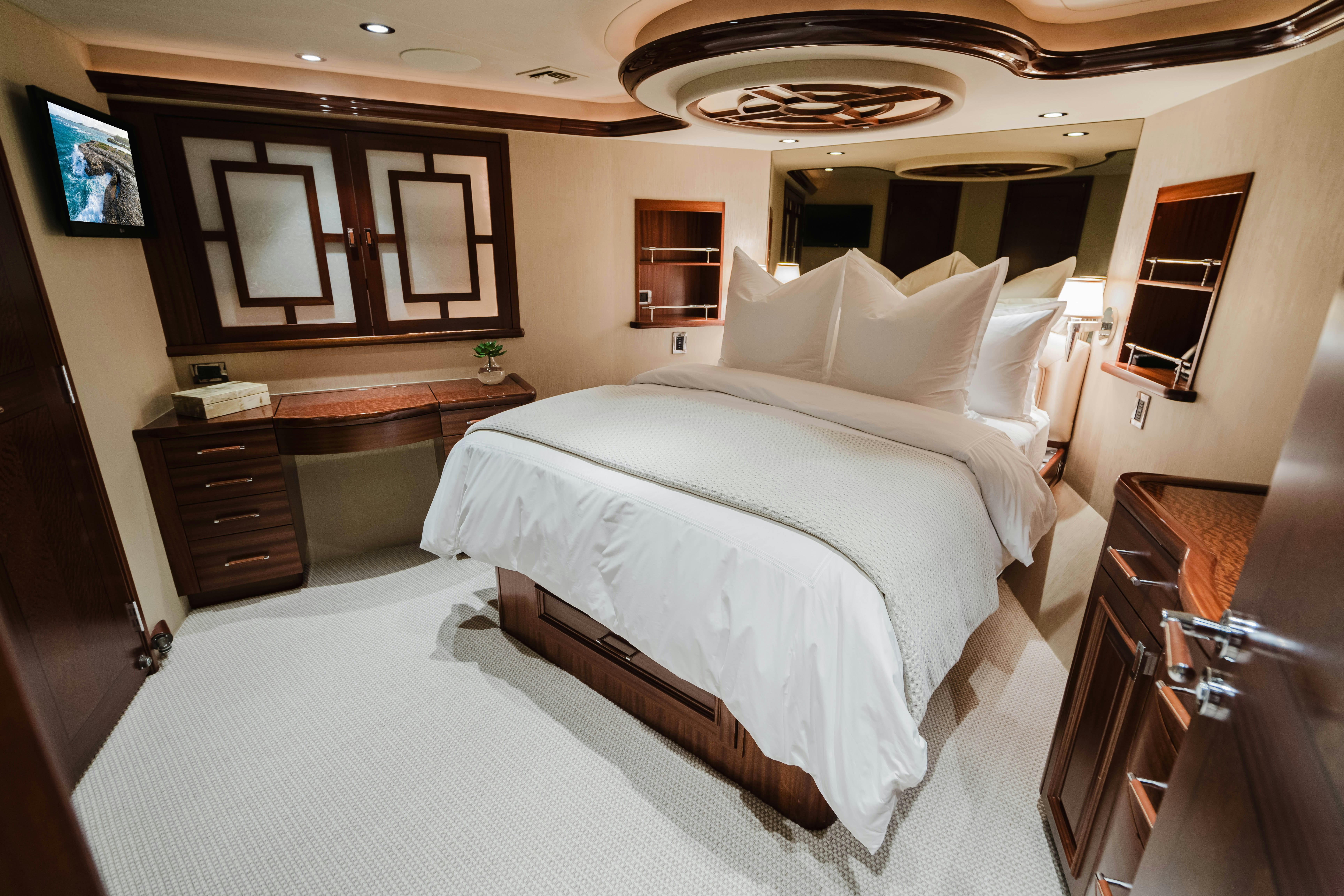 a room with a bed and a television aboard SEAQUINN Yacht for Sale