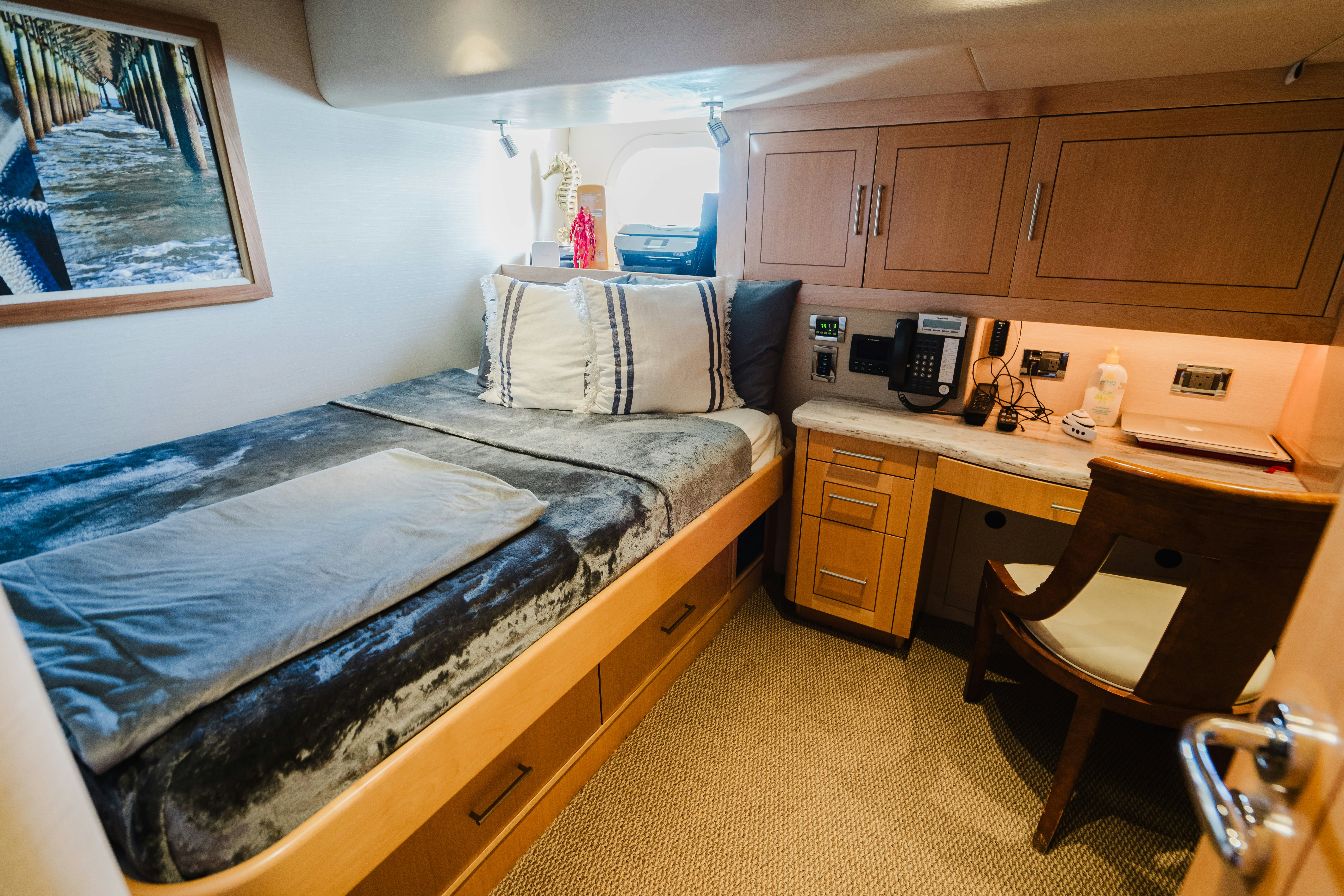 a bedroom with a bed and desk aboard SEAQUINN Yacht for Sale