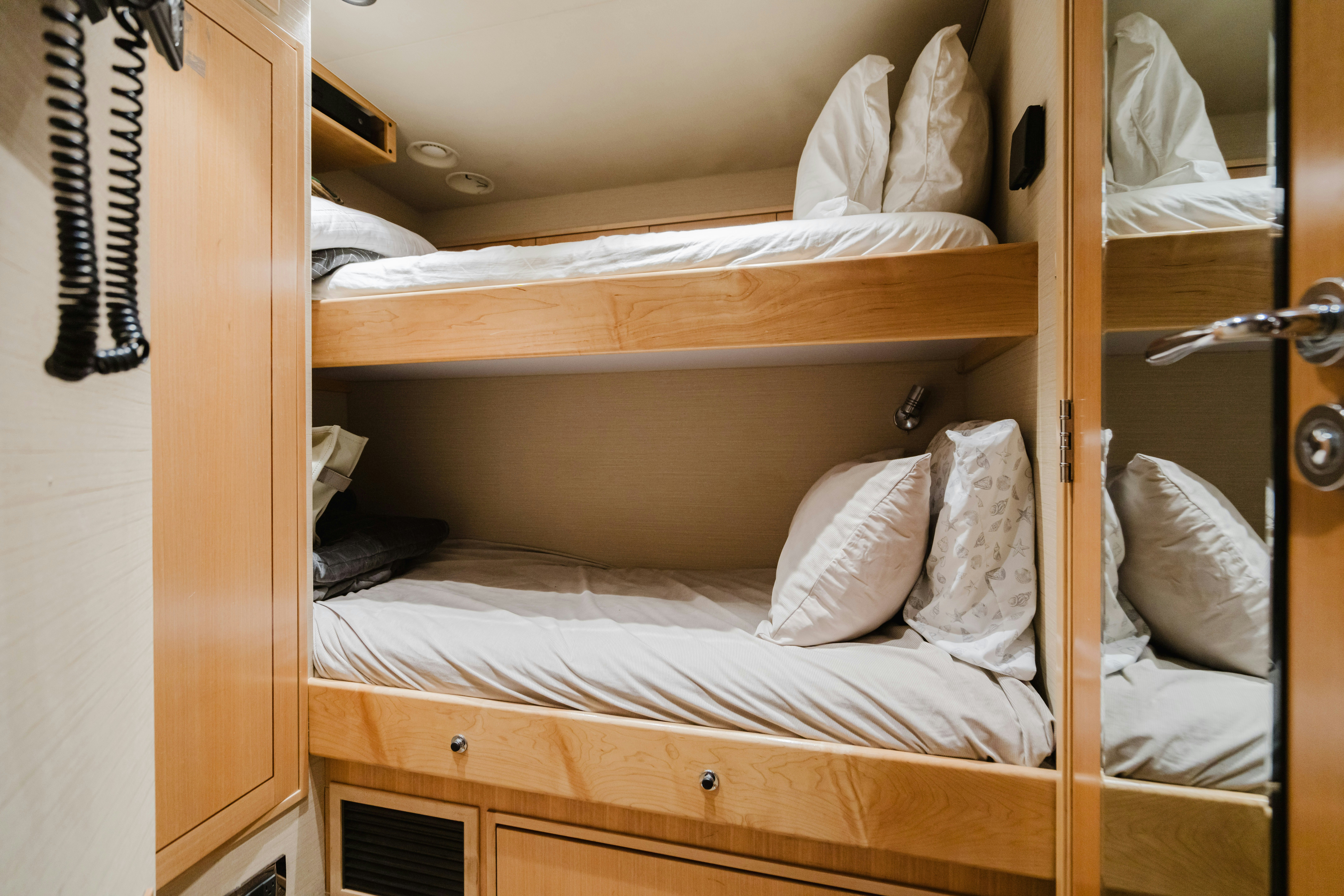 a bed with white sheets aboard SEAQUINN Yacht for Sale