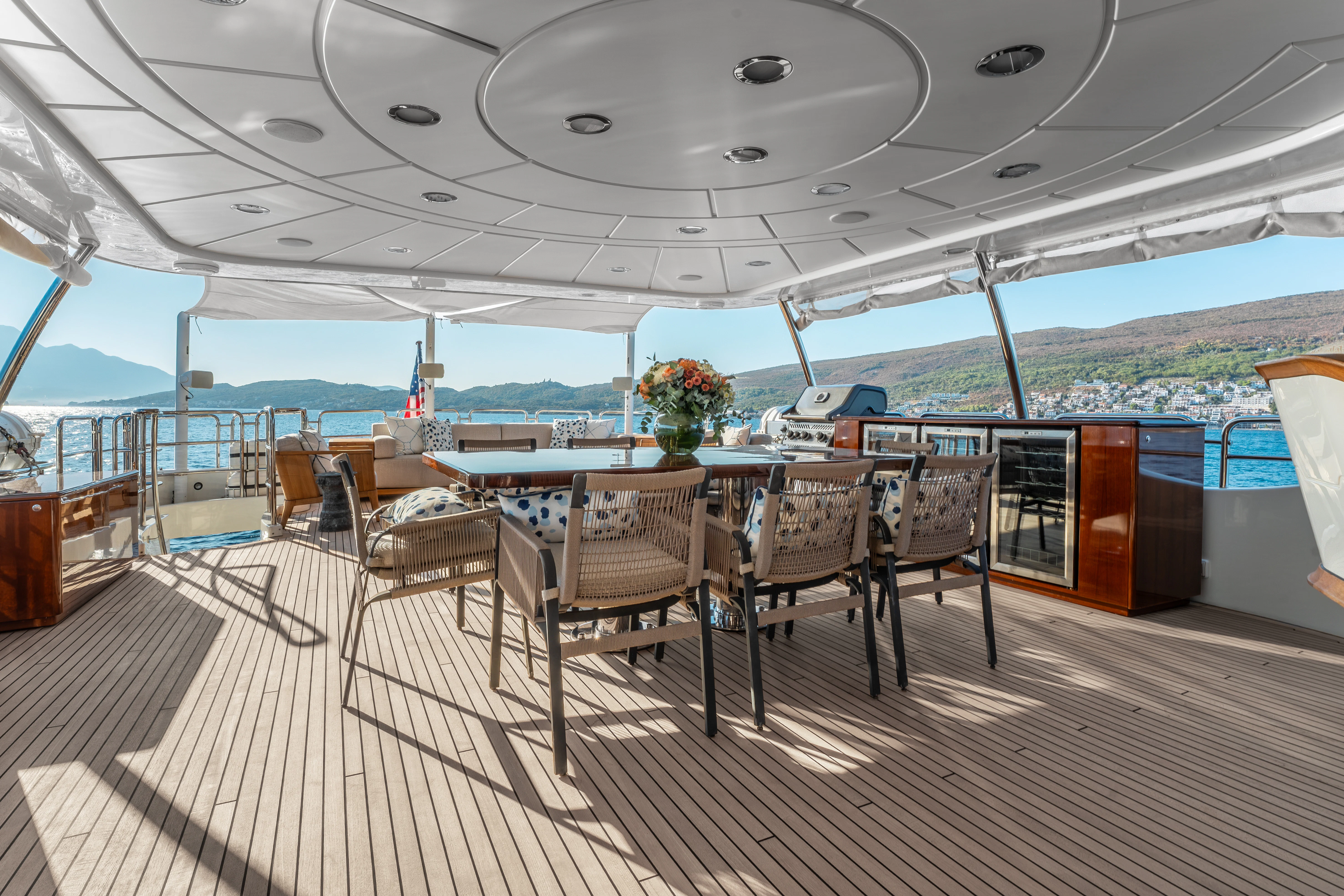 a deck with a table and chairs aboard ARTEMIS Yacht for Sale