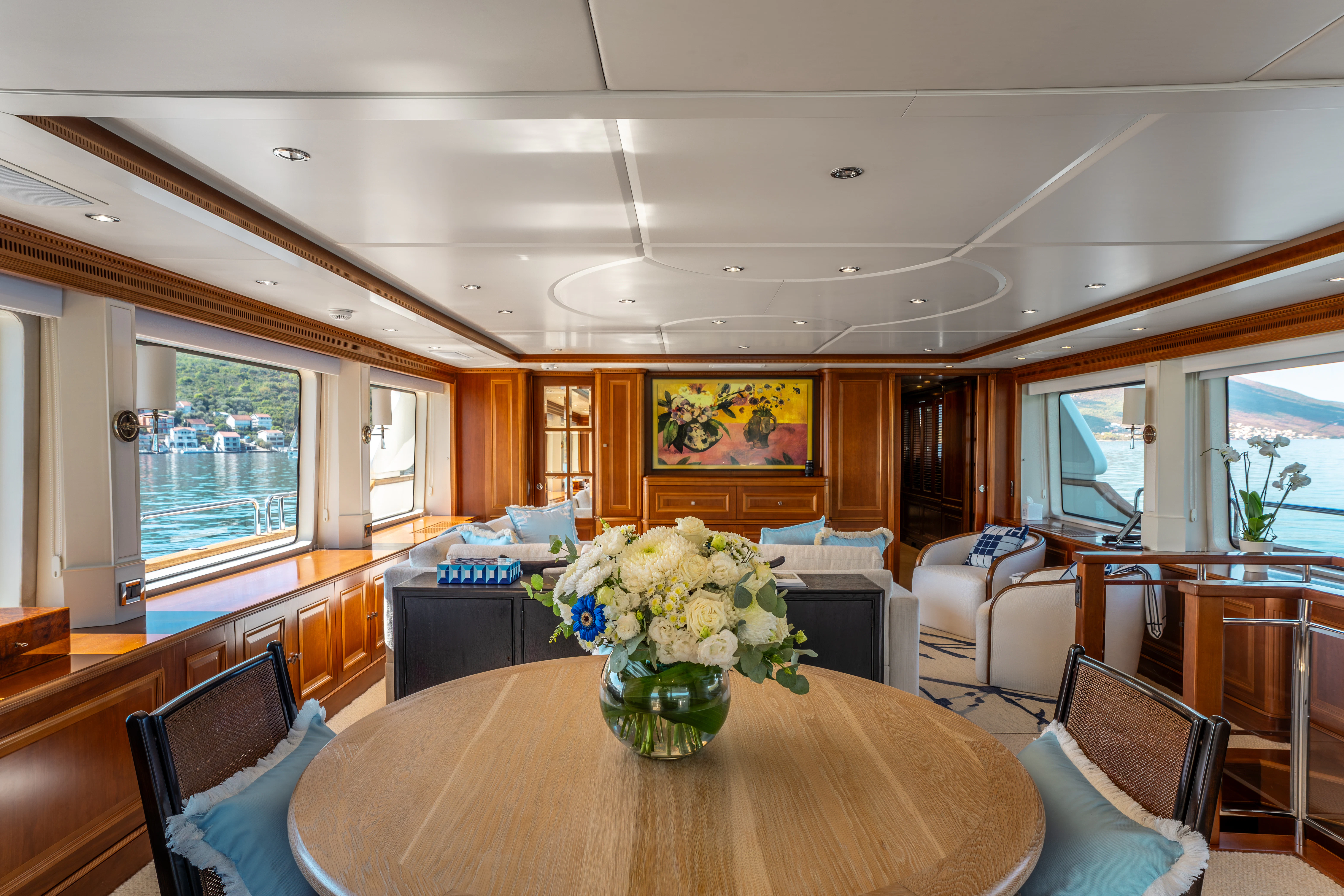 a large living room with a table and chairs aboard ARTEMIS Yacht for Sale
