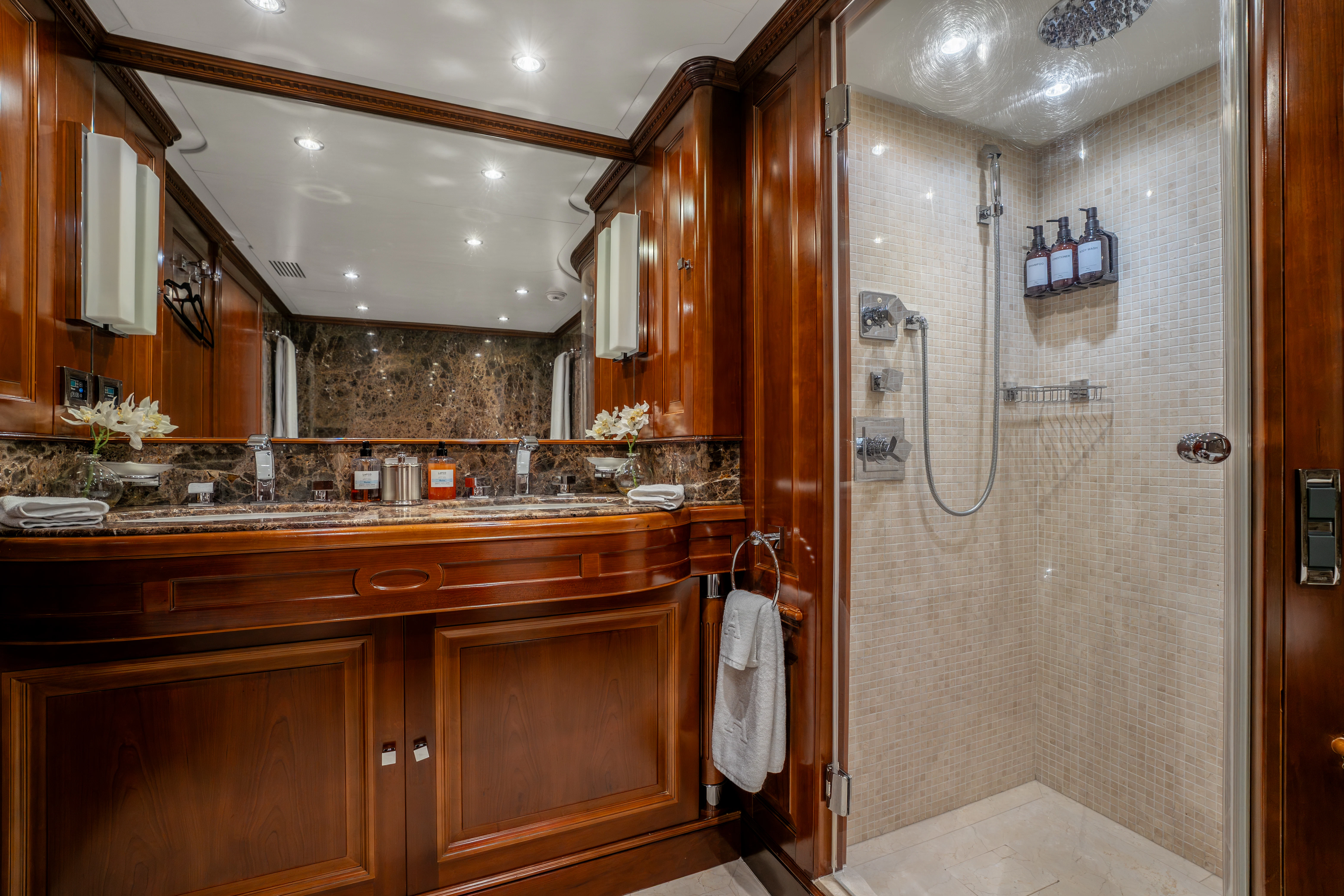 a bathroom with wooden cabinets aboard ARTEMIS Yacht for Sale