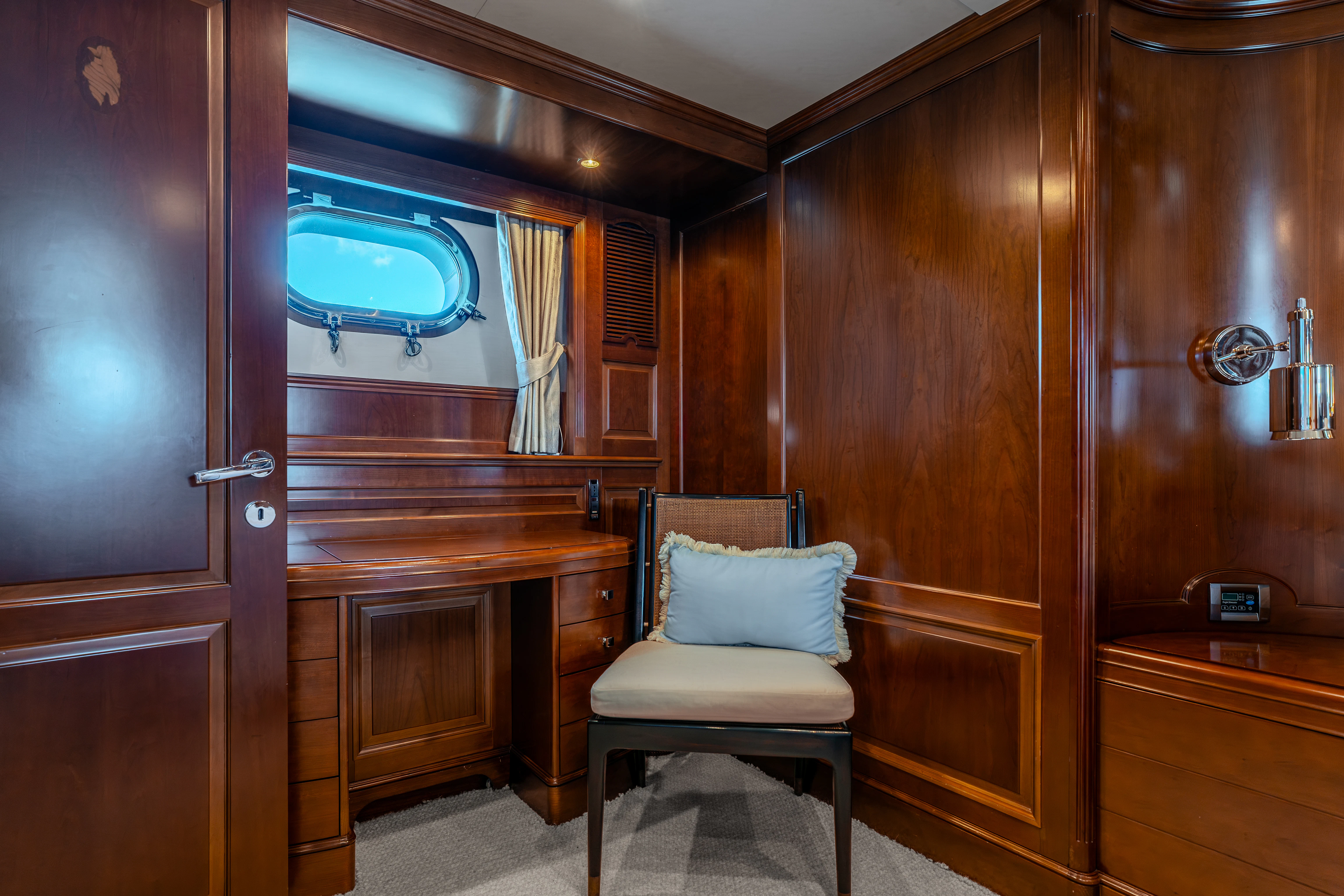 a room with a chair and a window aboard ARTEMIS Yacht for Sale