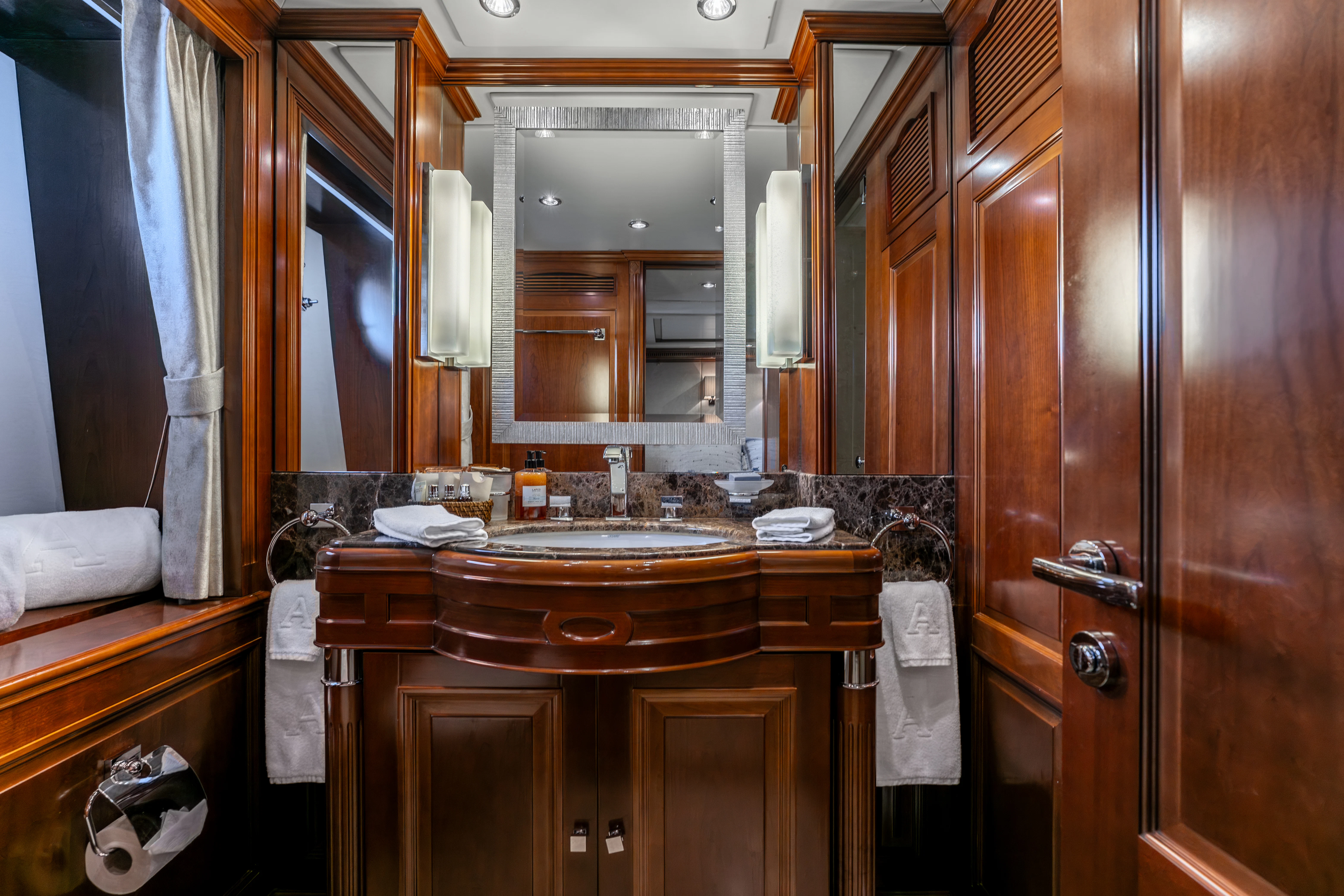 a bathroom with wooden cabinets aboard ARTEMIS Yacht for Sale