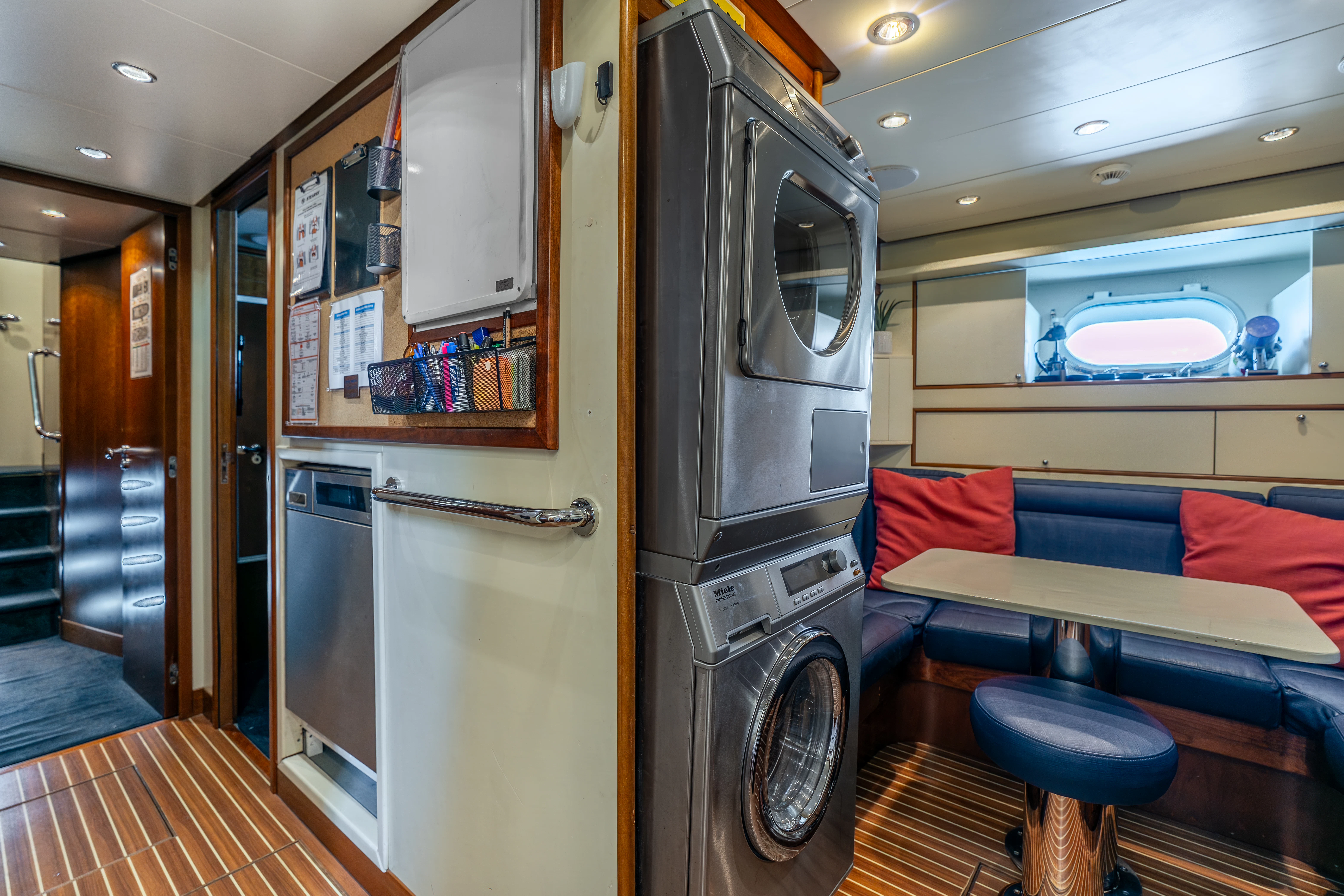 a kitchen with a fridge and a couch aboard ARTEMIS Yacht for Sale