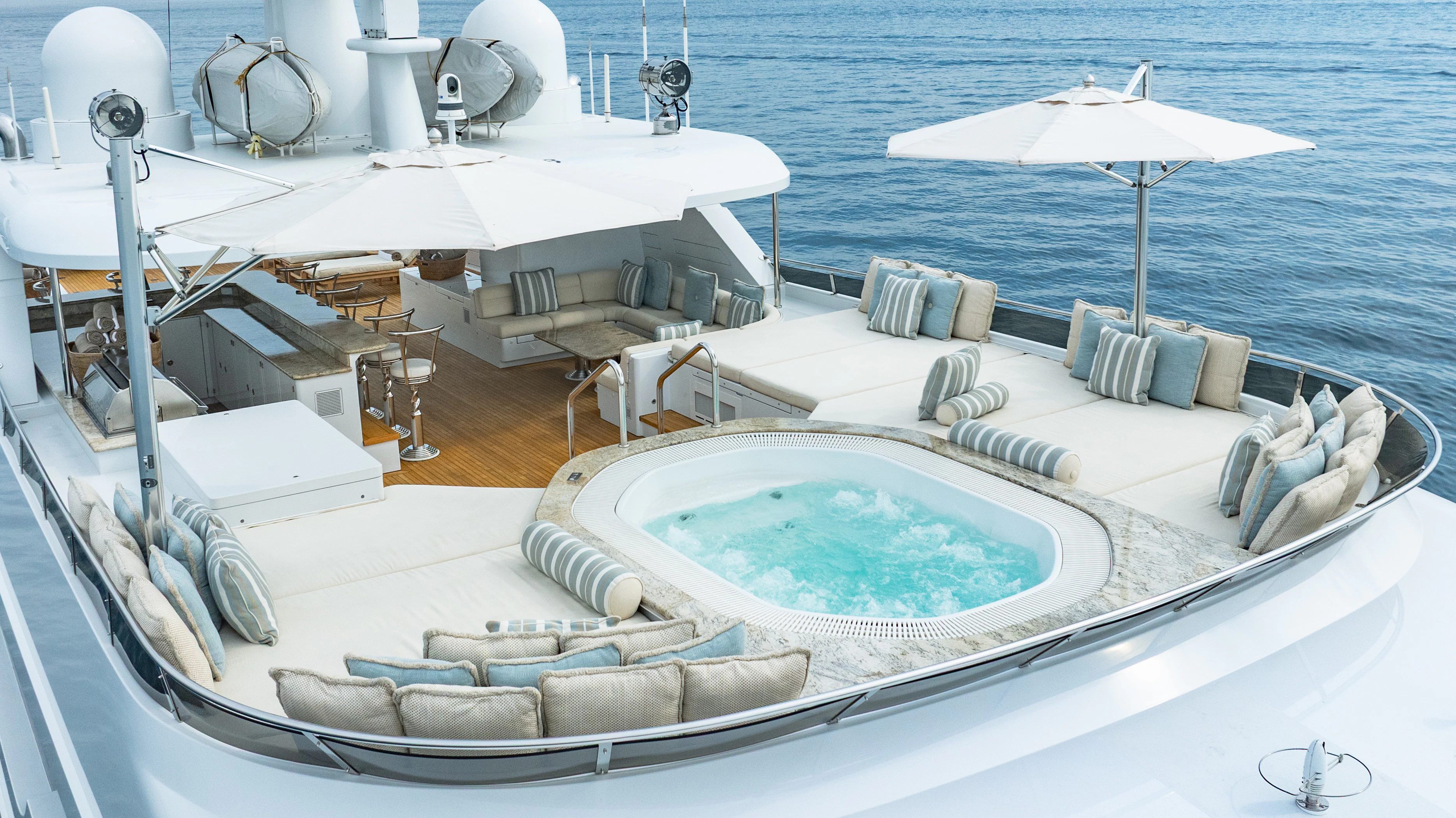 a large white boat with a large white umbrella on it aboard SILVER LINING Yacht for Sale