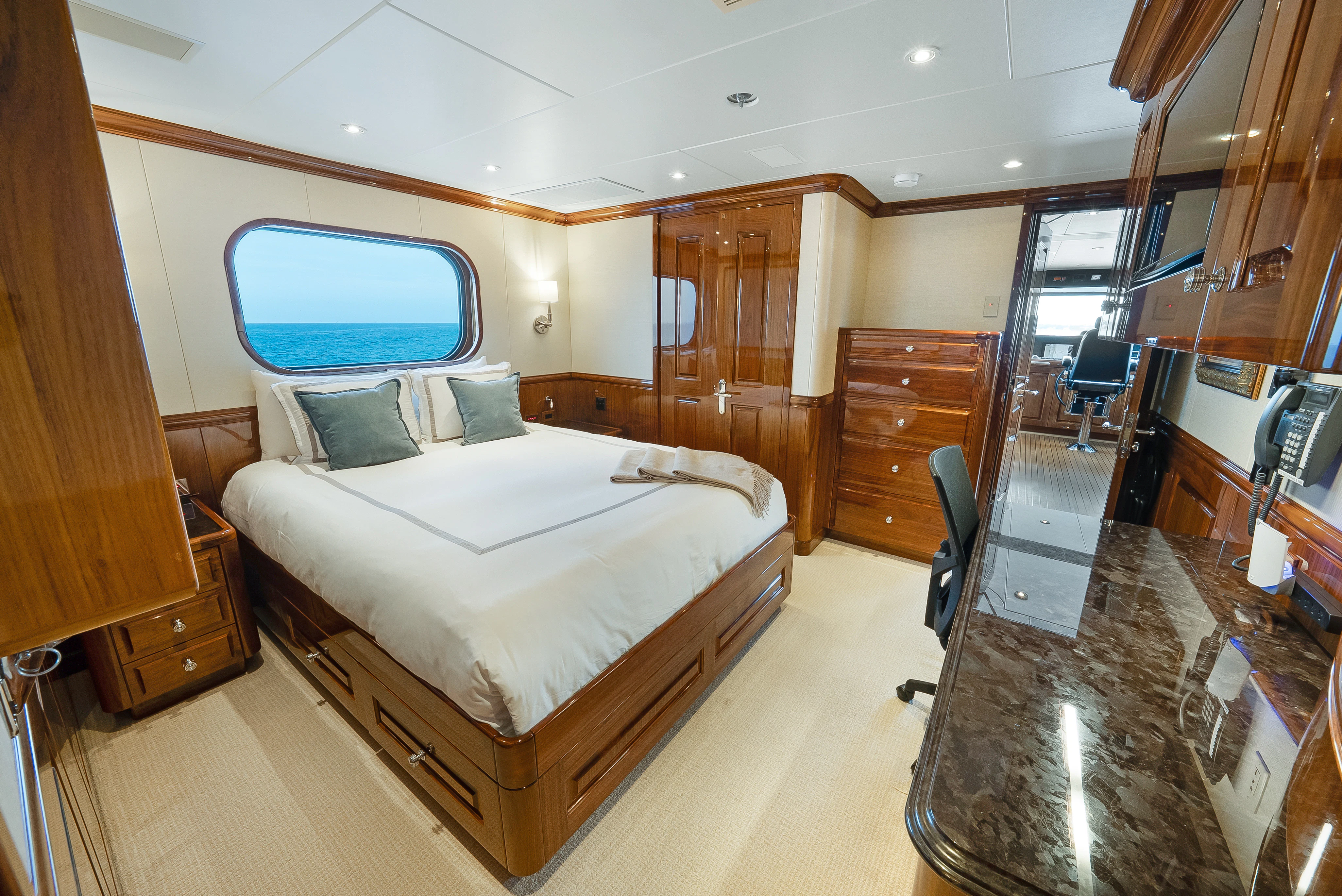 a bedroom with a bed and a desk aboard SILVER LINING Yacht for Sale