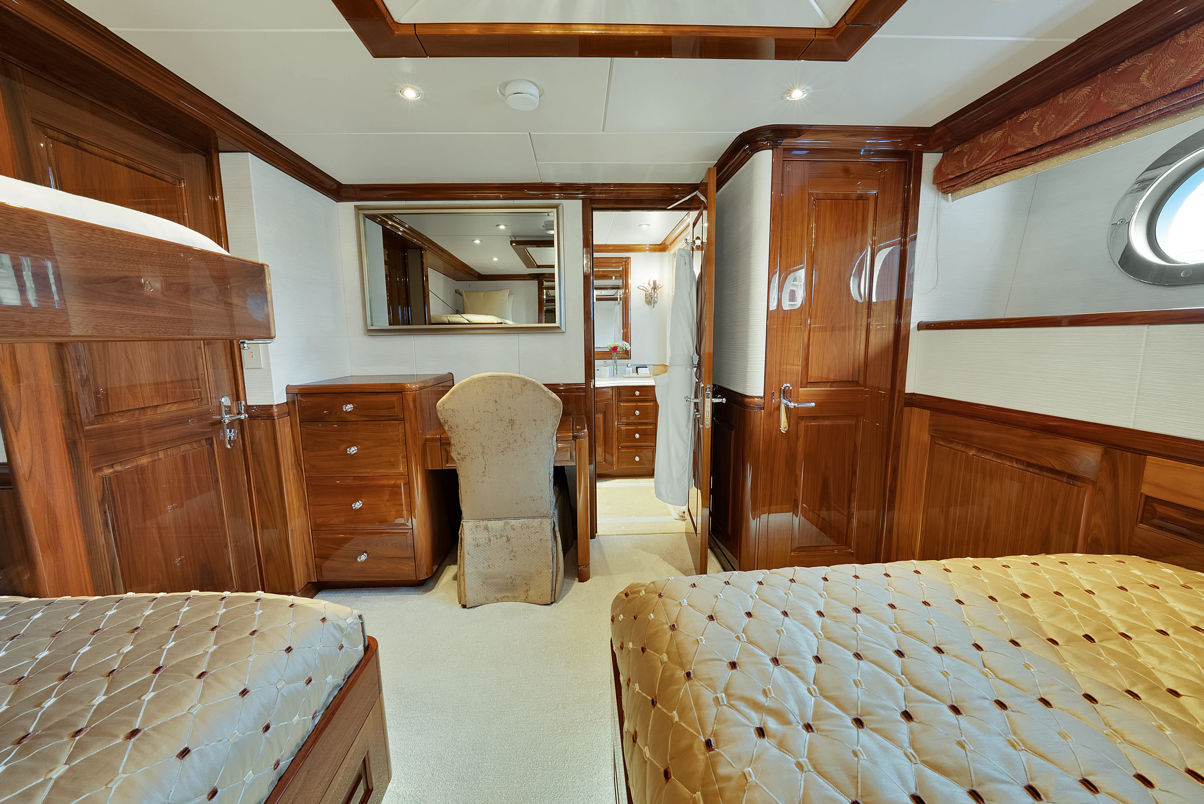 a bedroom with a bed and a desk aboard SILVER LINING Yacht for Sale