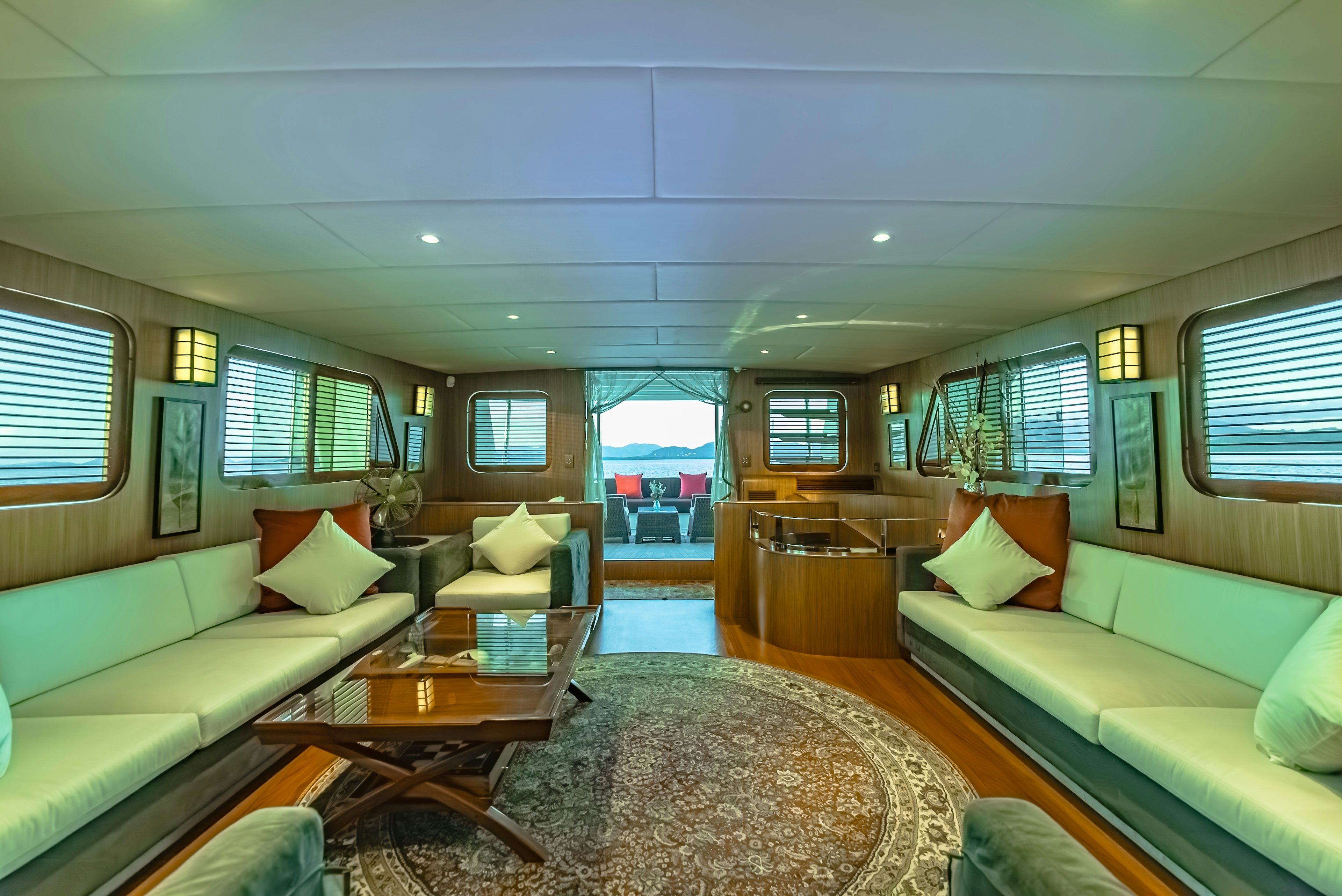 a living room with a couch and a table aboard THEA Yacht for Sale