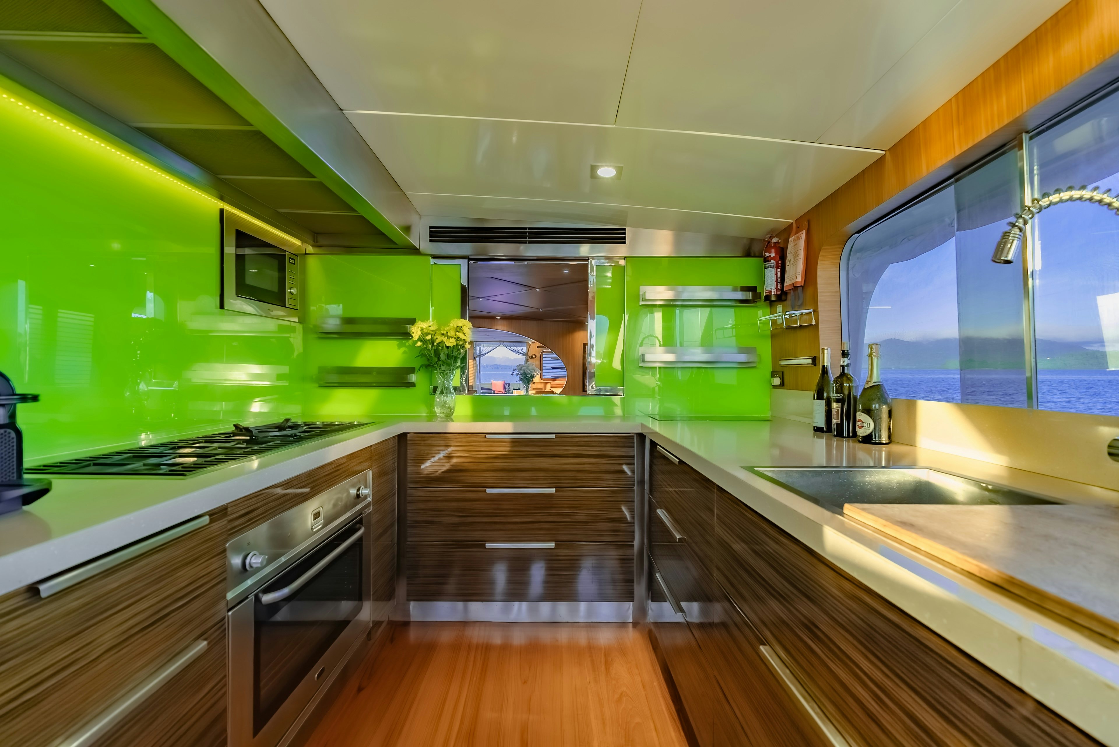 a kitchen with a green wall aboard THEA Yacht for Sale