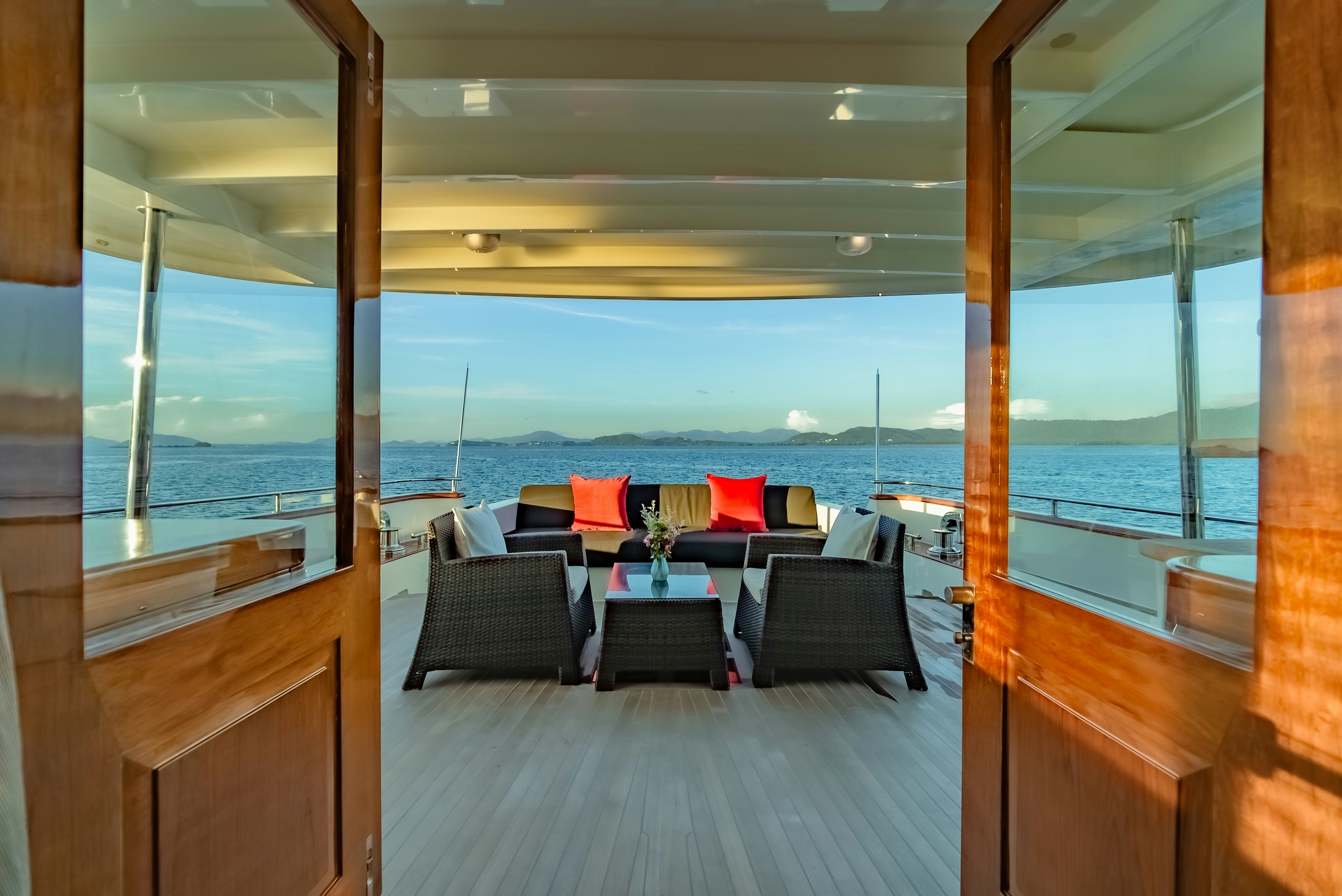 a room with a view of the ocean and a deck aboard THEA Yacht for Sale