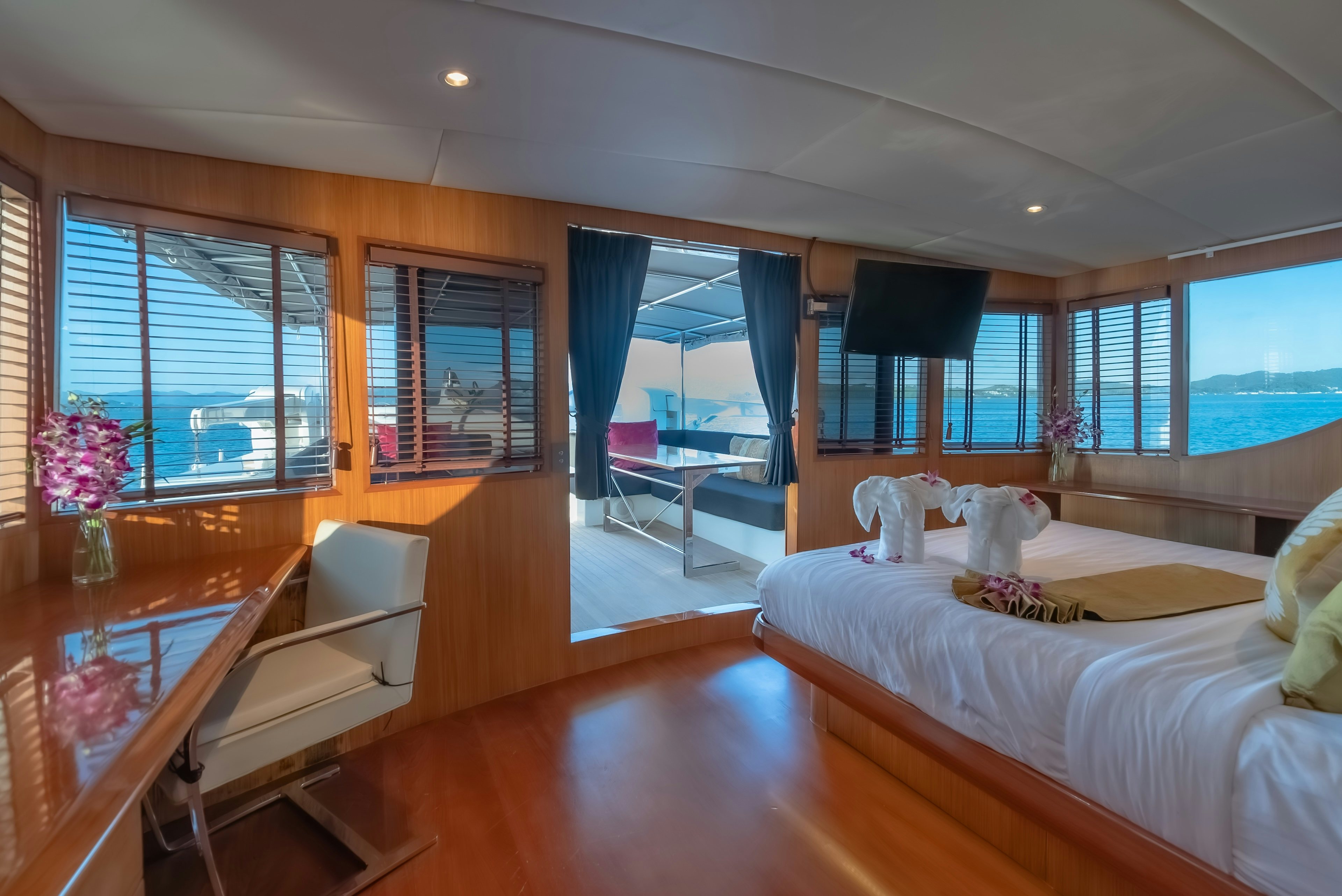 a bedroom with a large bed aboard THEA Yacht for Sale