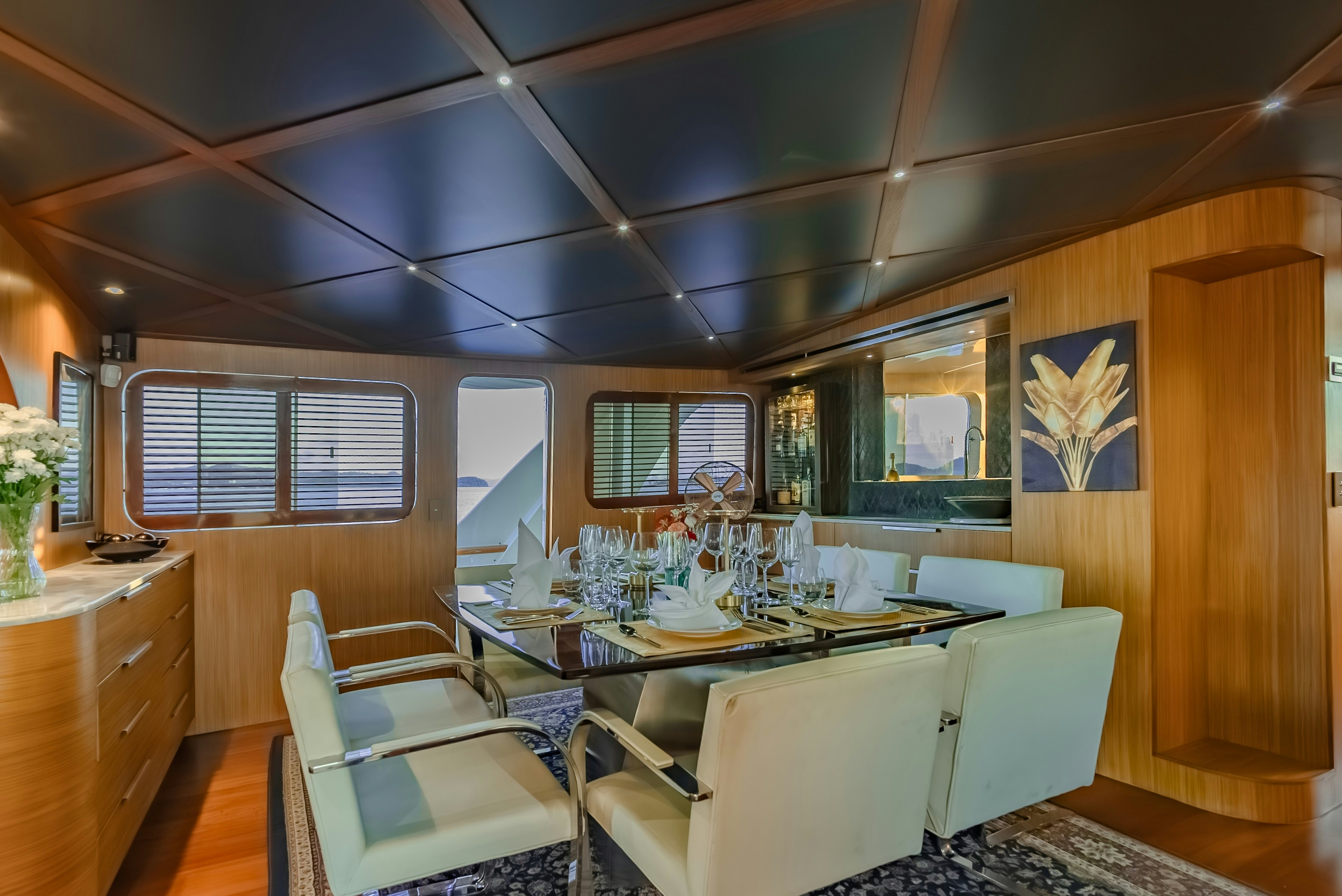 a dining room with a table and chairs aboard THEA Yacht for Sale