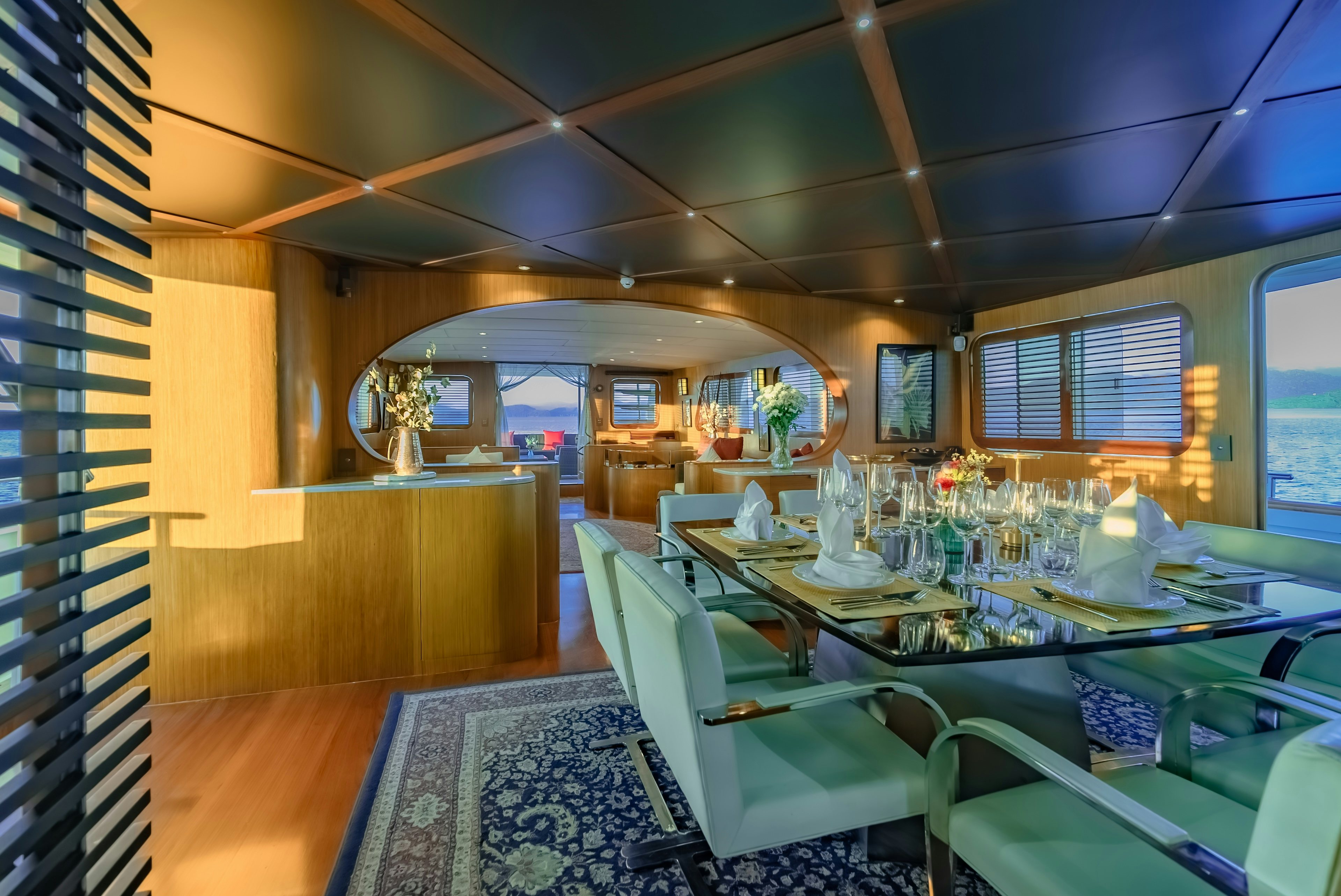 a room with tables and chairs aboard THEA Yacht for Sale