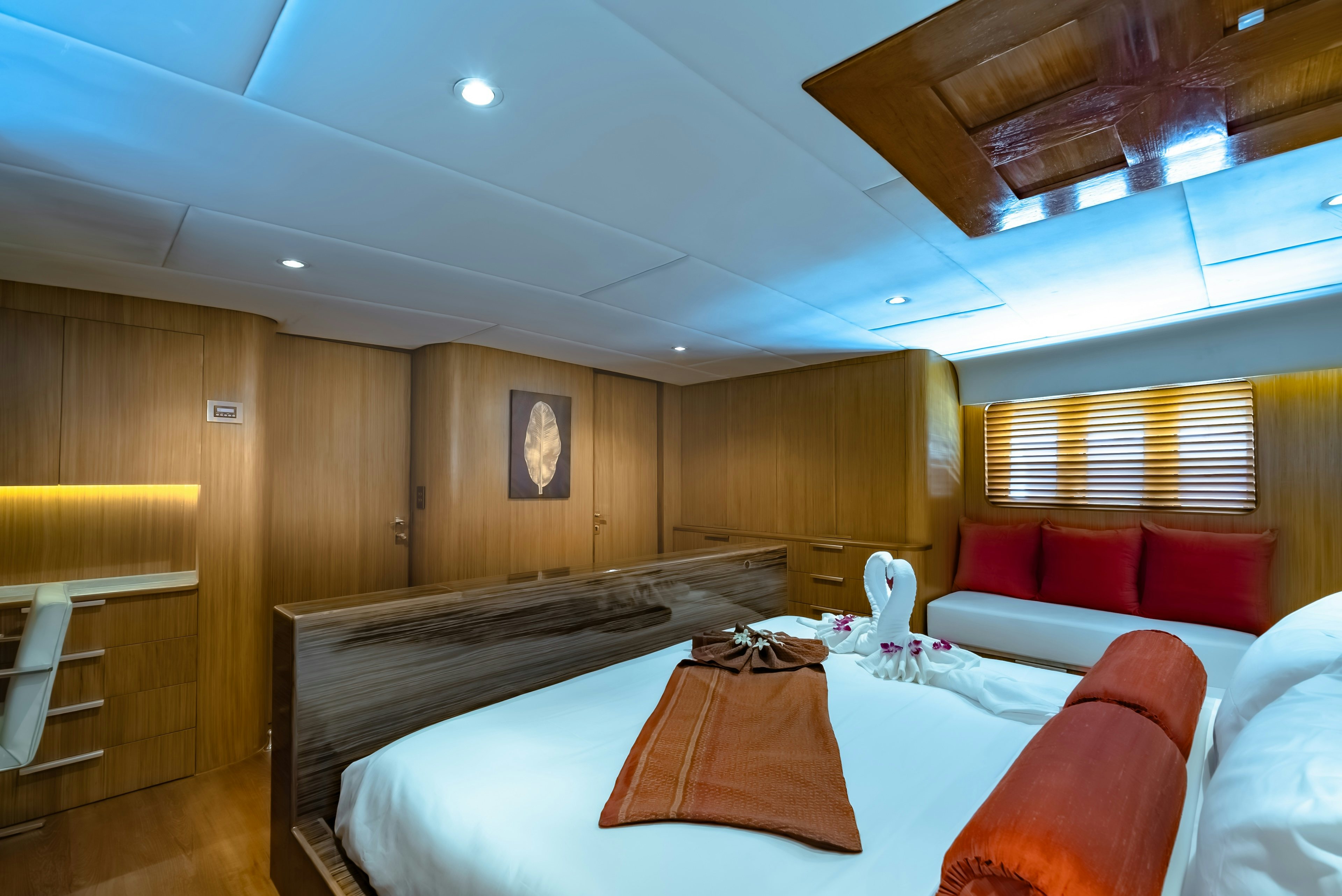 a room with a bed and a couch aboard THEA Yacht for Sale
