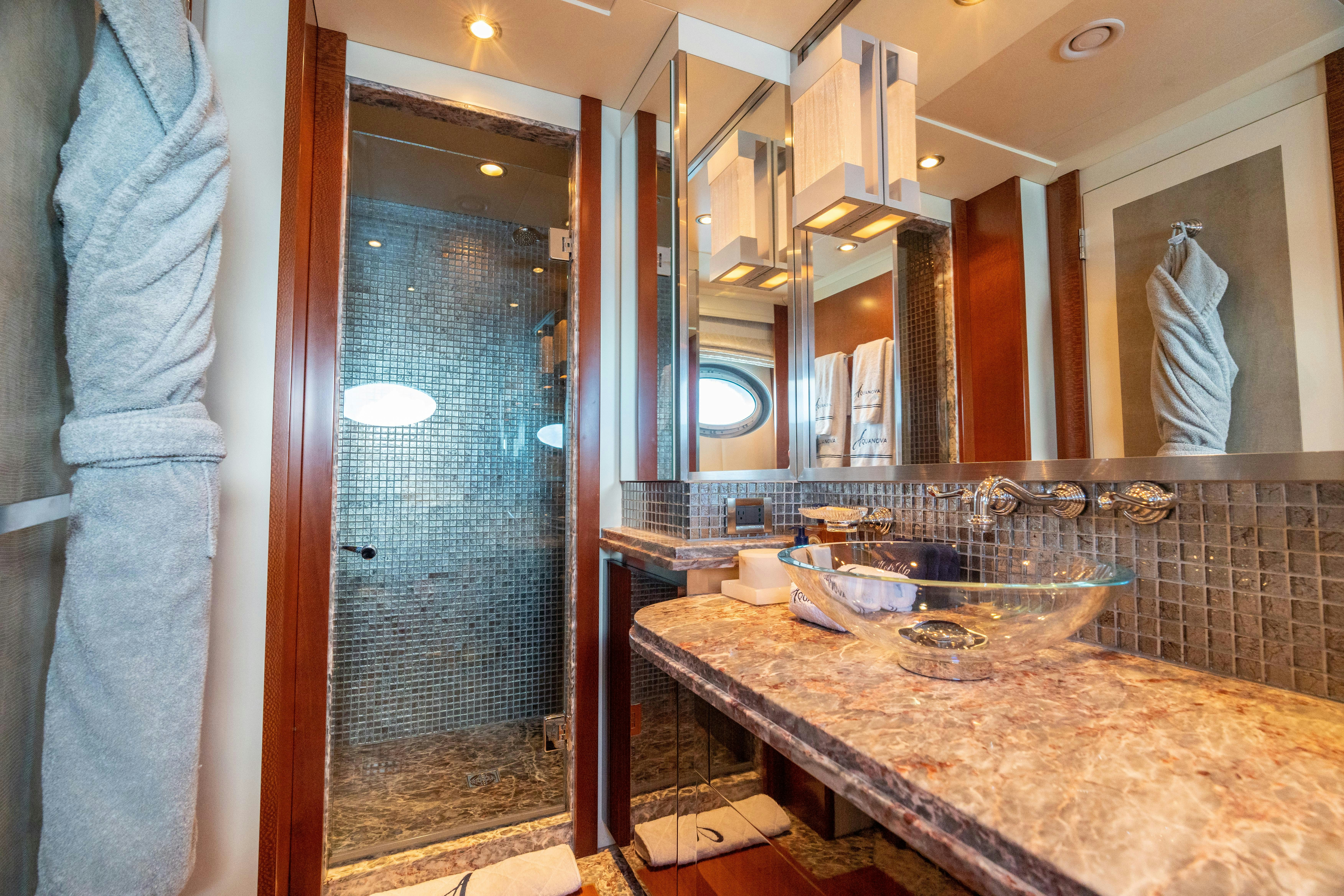 a bathroom with a countertop sink and a mirror aboard AQUANOVA Yacht for Charter