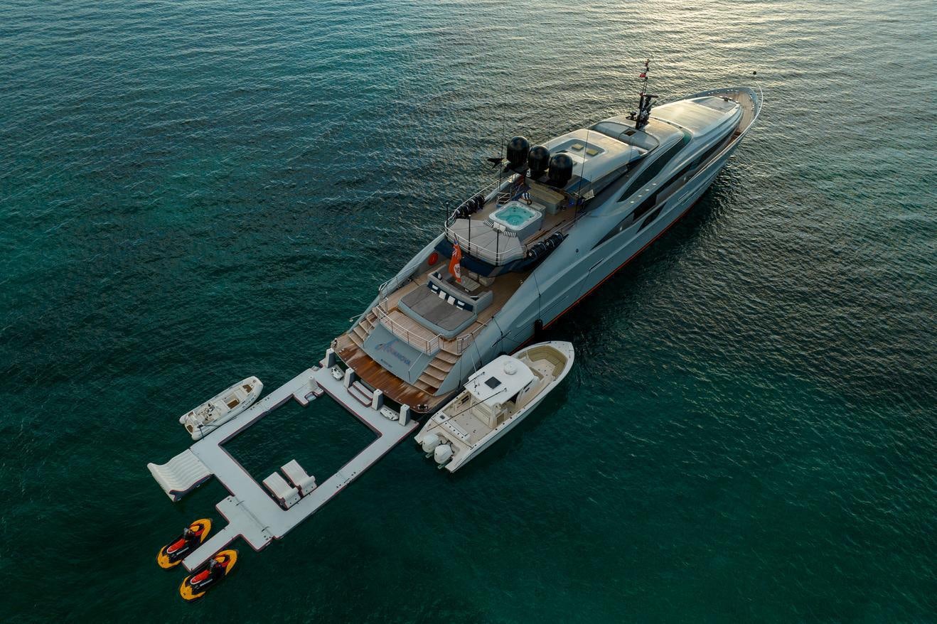 a large military ship in the water aboard AQUANOVA Yacht for Charter