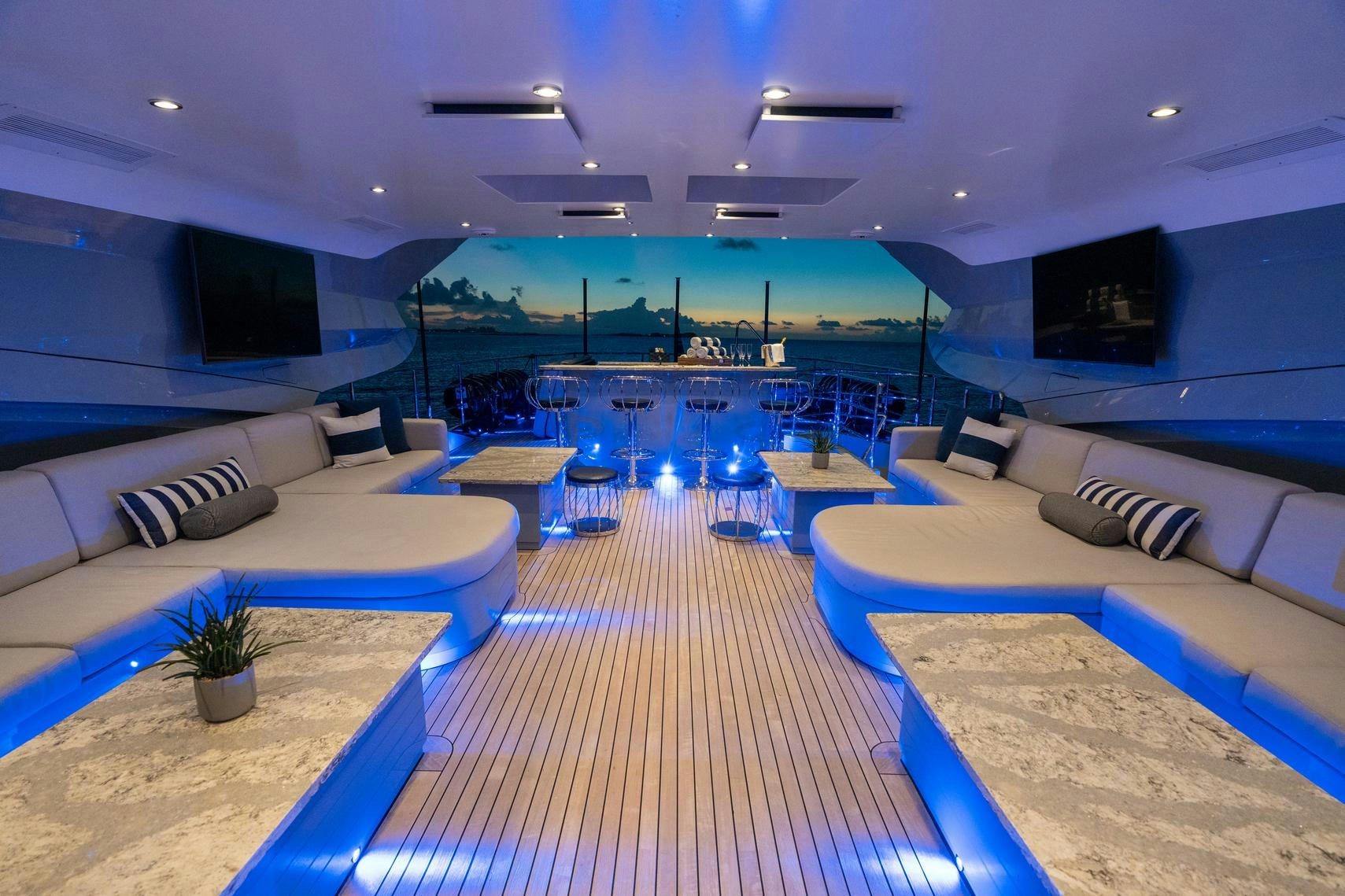 a room with a pool and a deck with a view of the ocean aboard AQUANOVA Yacht for Charter