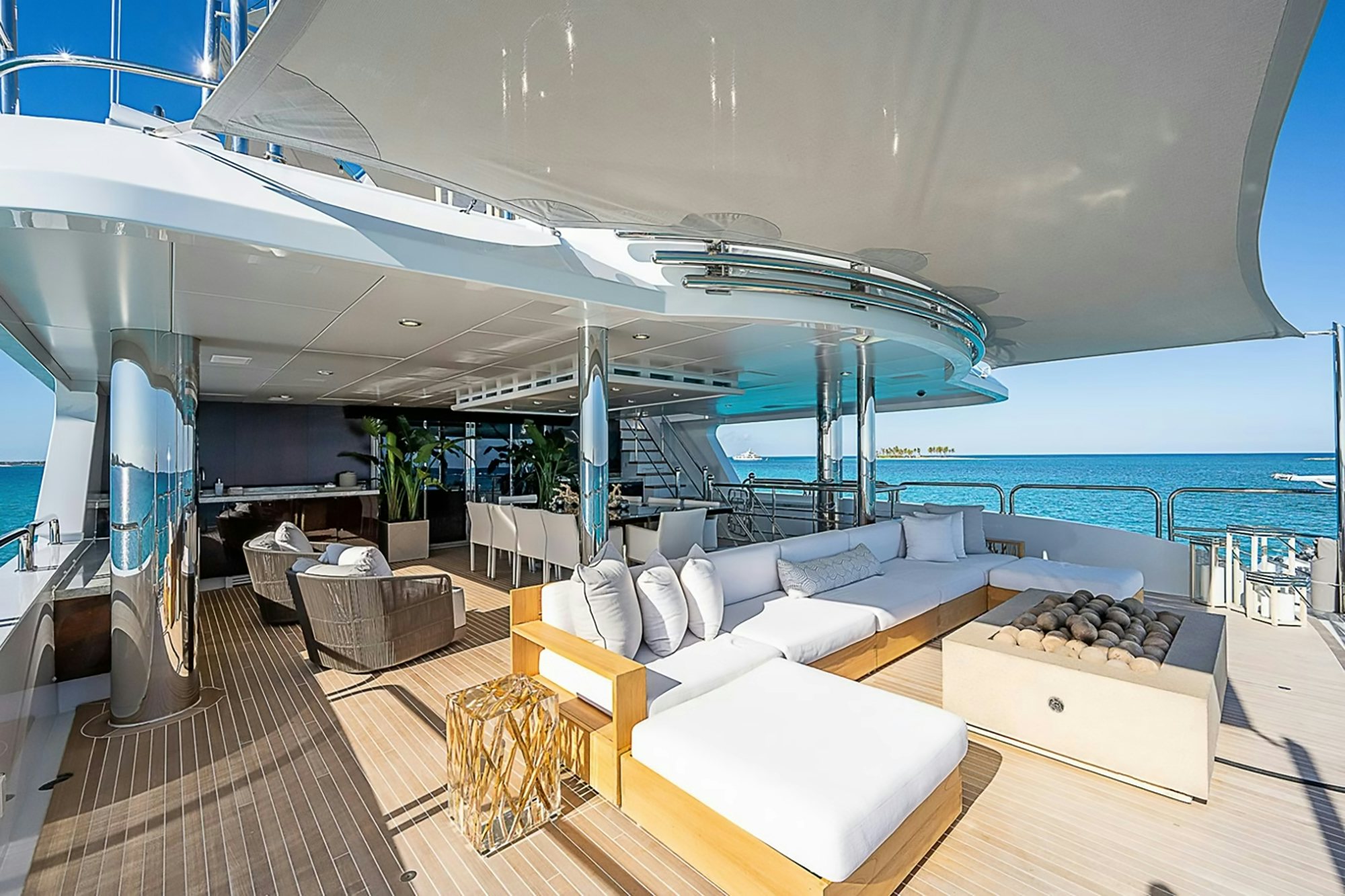 a modern living room with a large balcony overlooking the ocean aboard MISS MICHELLE Yacht for Charter