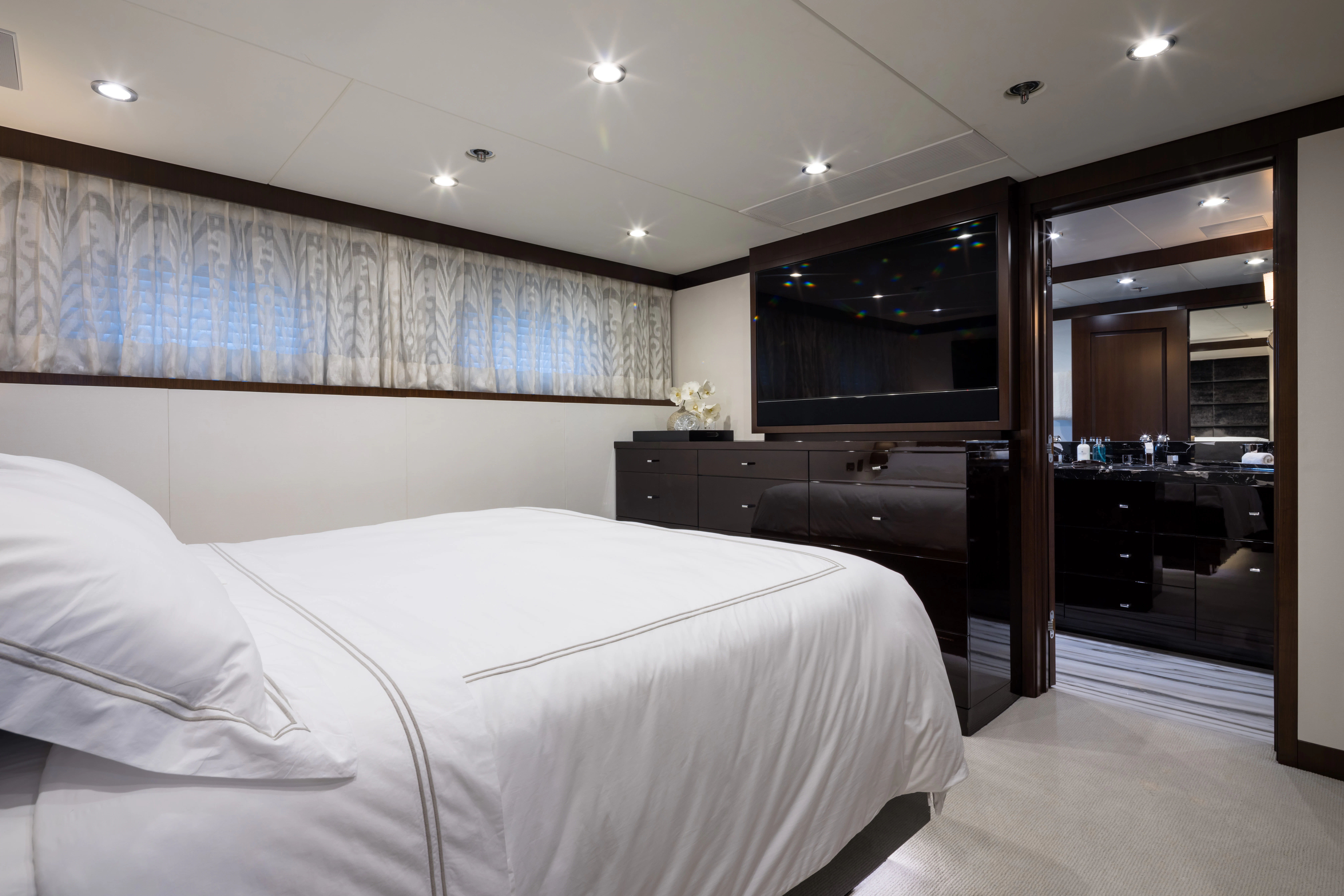 a bedroom with a bed and a tv aboard MISS MICHELLE Yacht for Charter