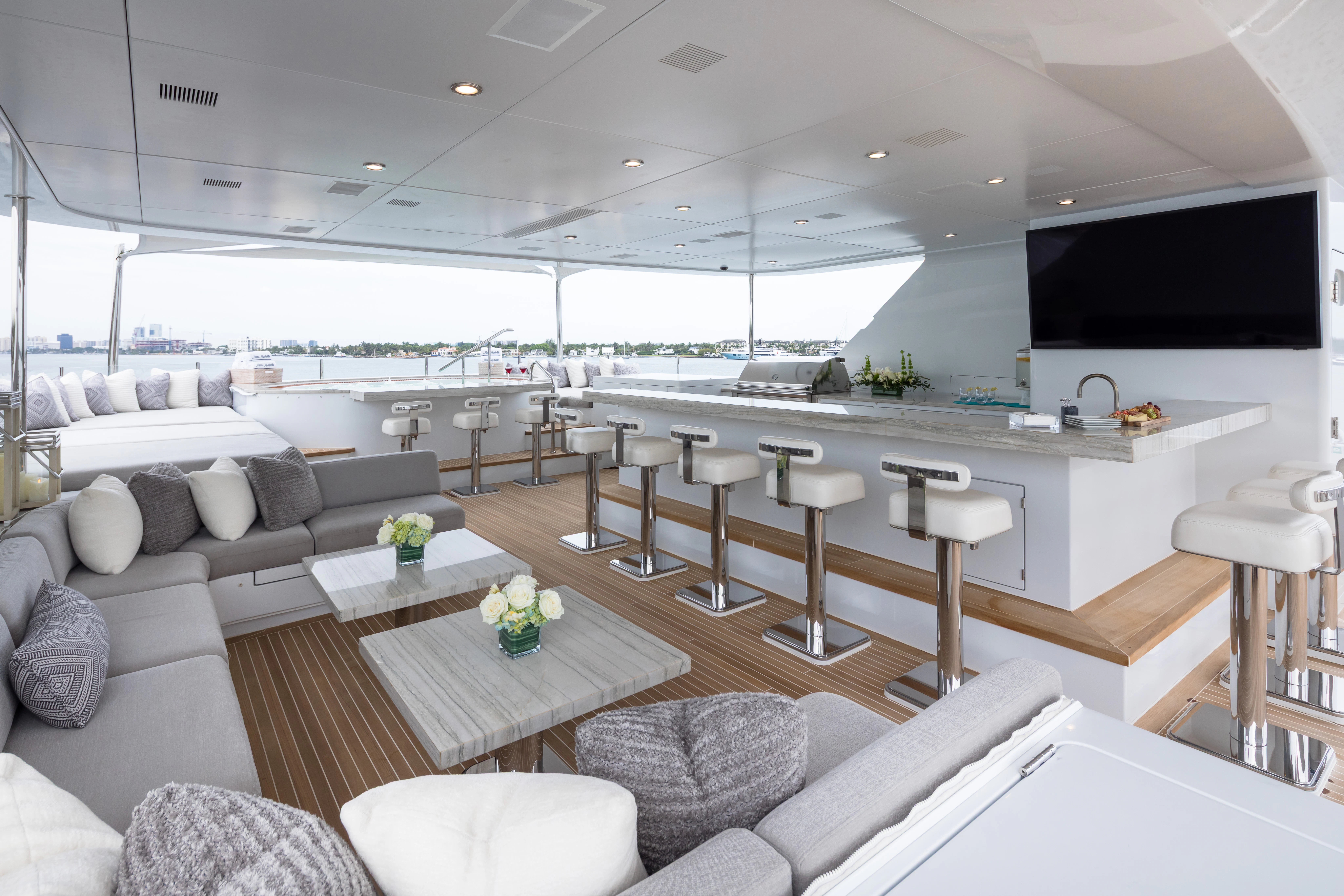 a modern living room with a large open kitchen and dining area aboard MISS MICHELLE Yacht for Charter
