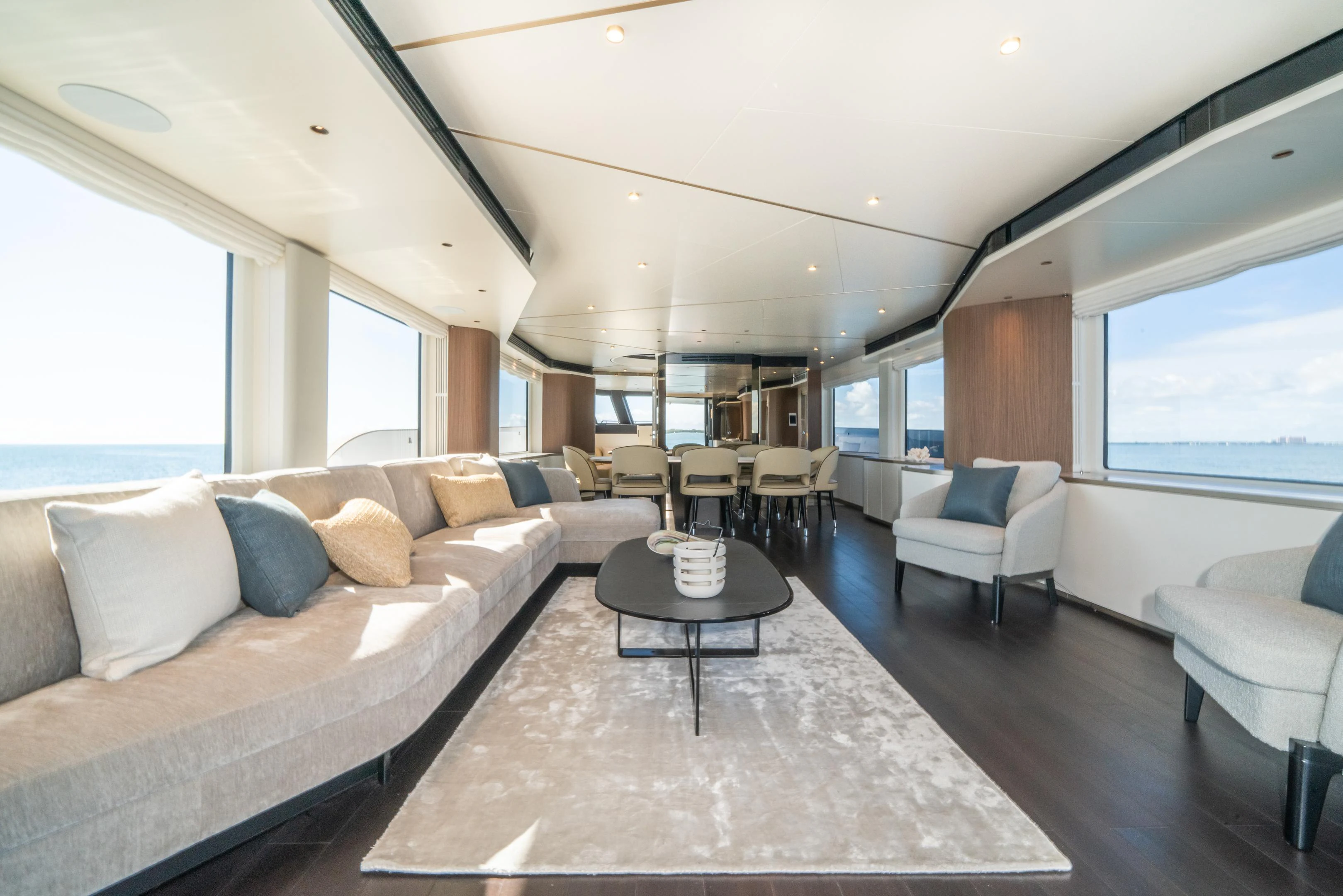 a living room with a large sofa aboard GUBA TIMES Yacht for Charter