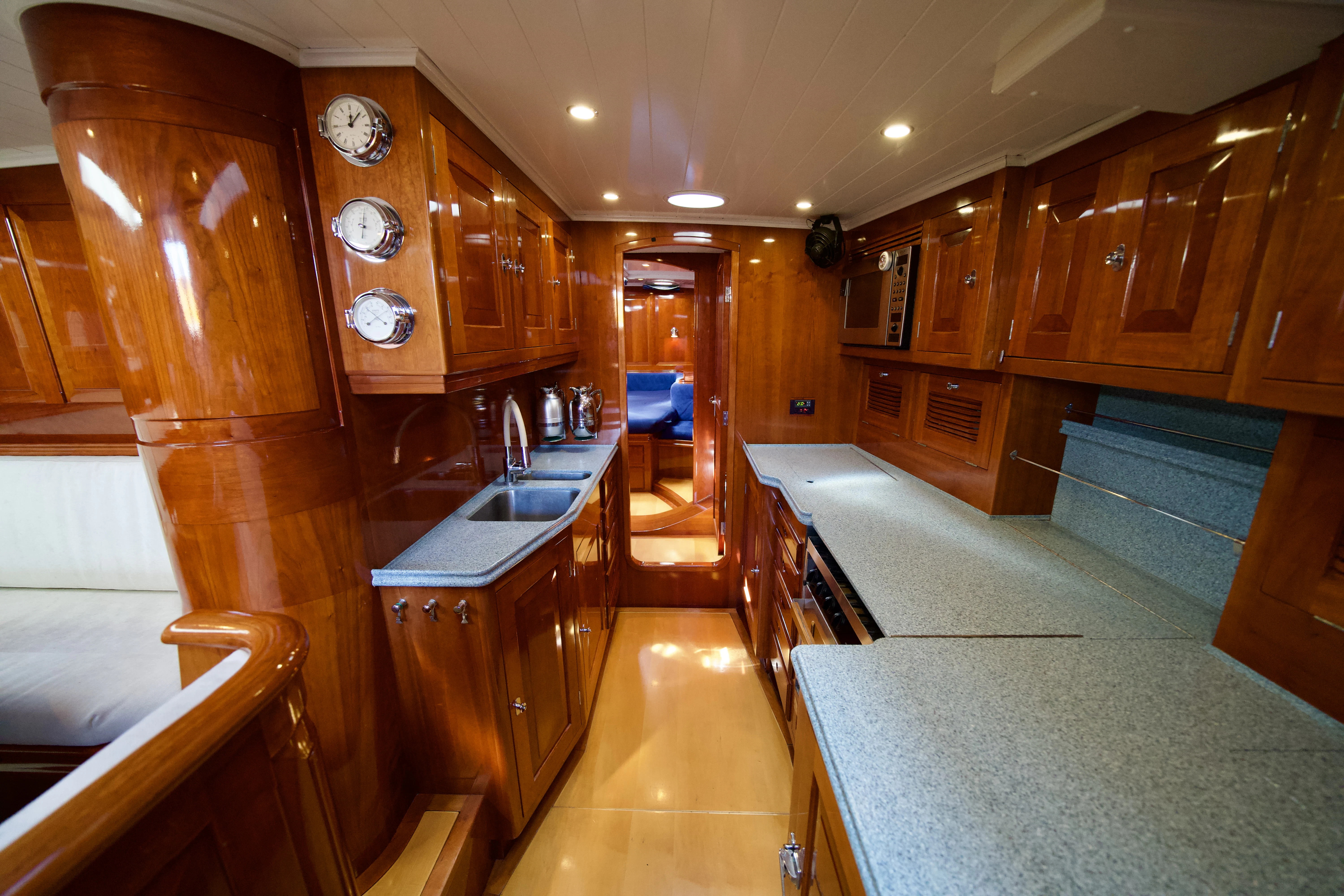 a large kitchen with wooden cabinets aboard ISABEL Yacht for Sale
