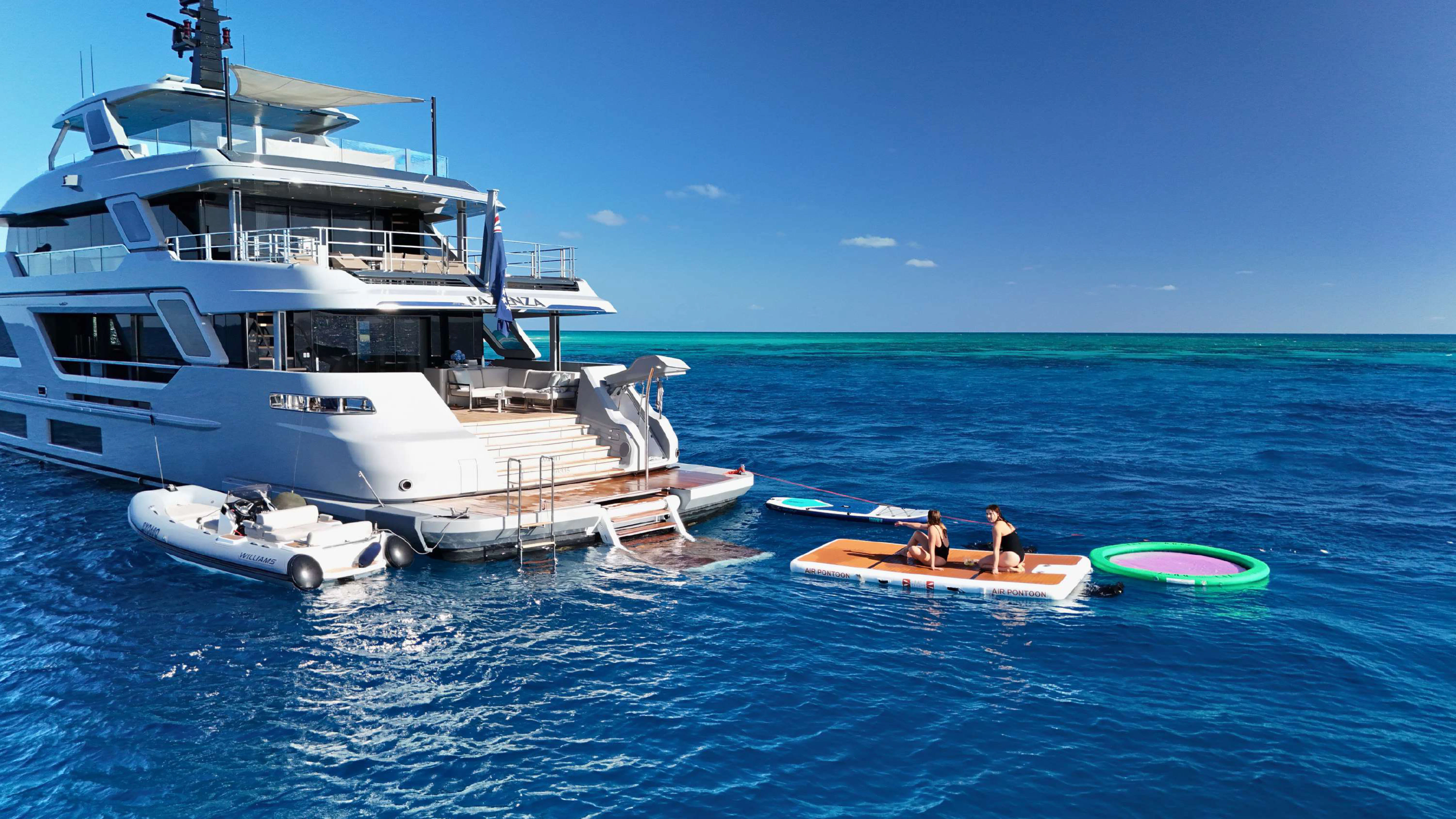 a boat and a couple of people in the water aboard PAZIENZA Yacht for Charter