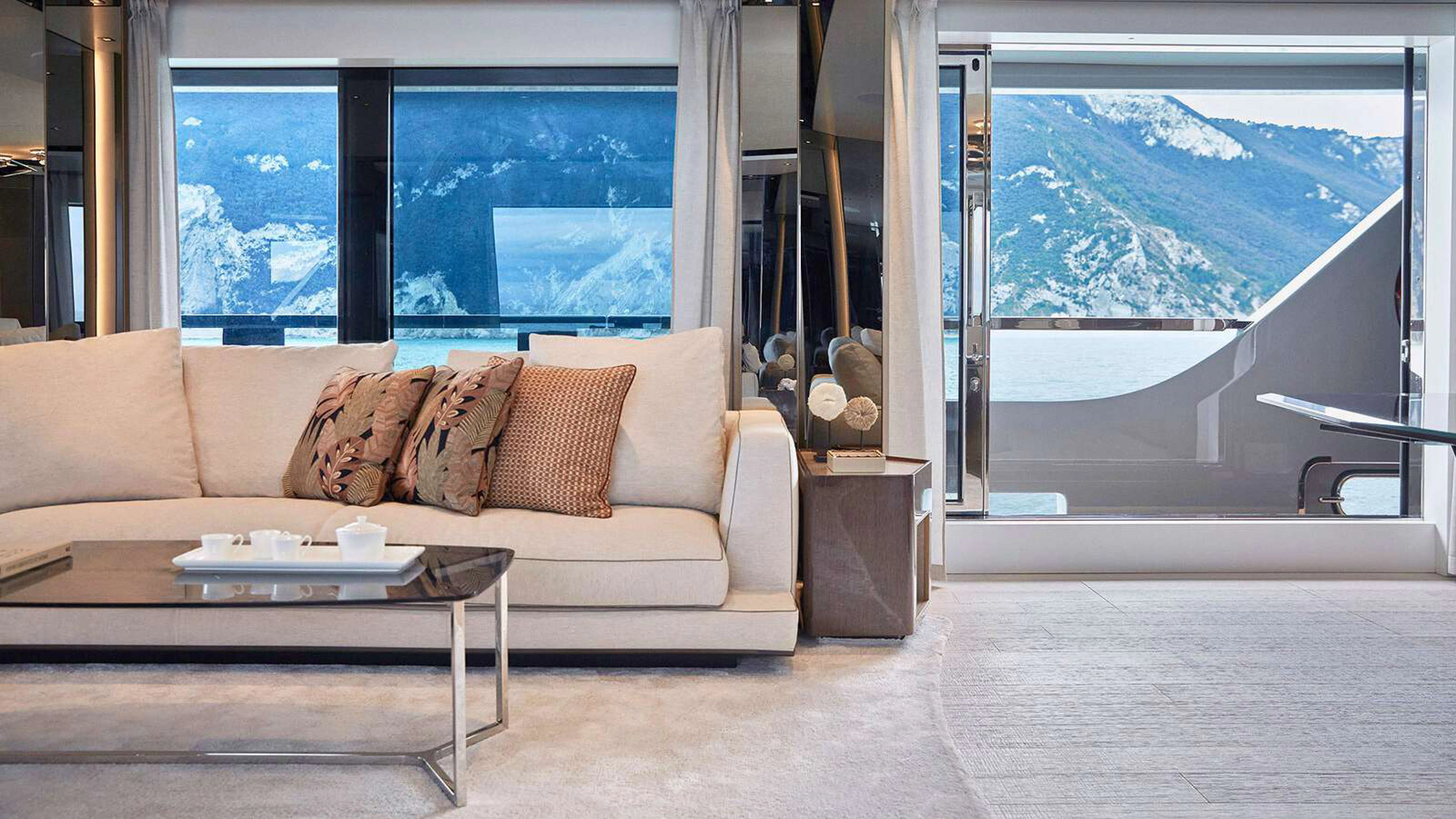a living room with a large window aboard PAZIENZA Yacht for Charter